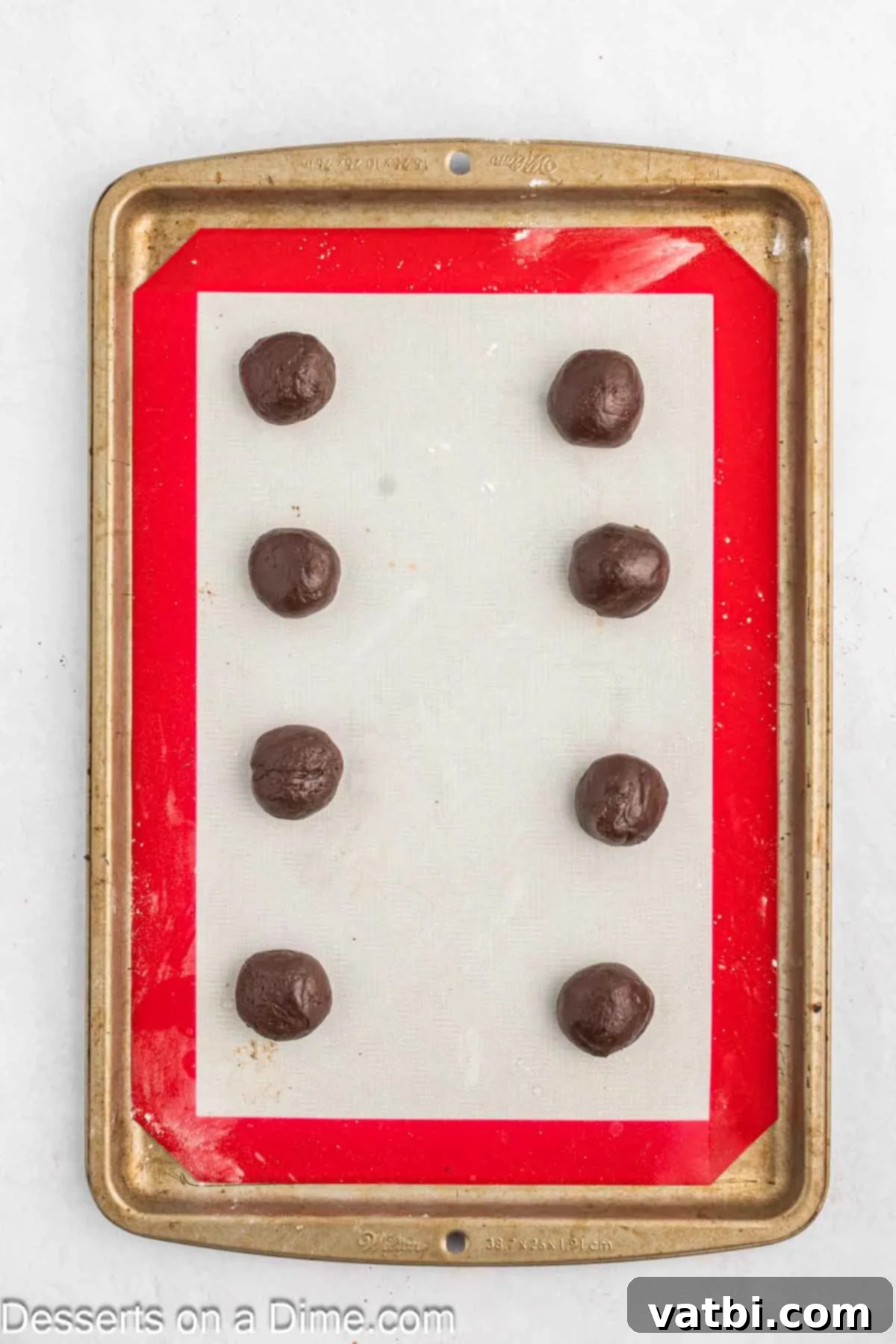 Decadent Whoopie Pies 6 Balls of cookie dough on baking mat.