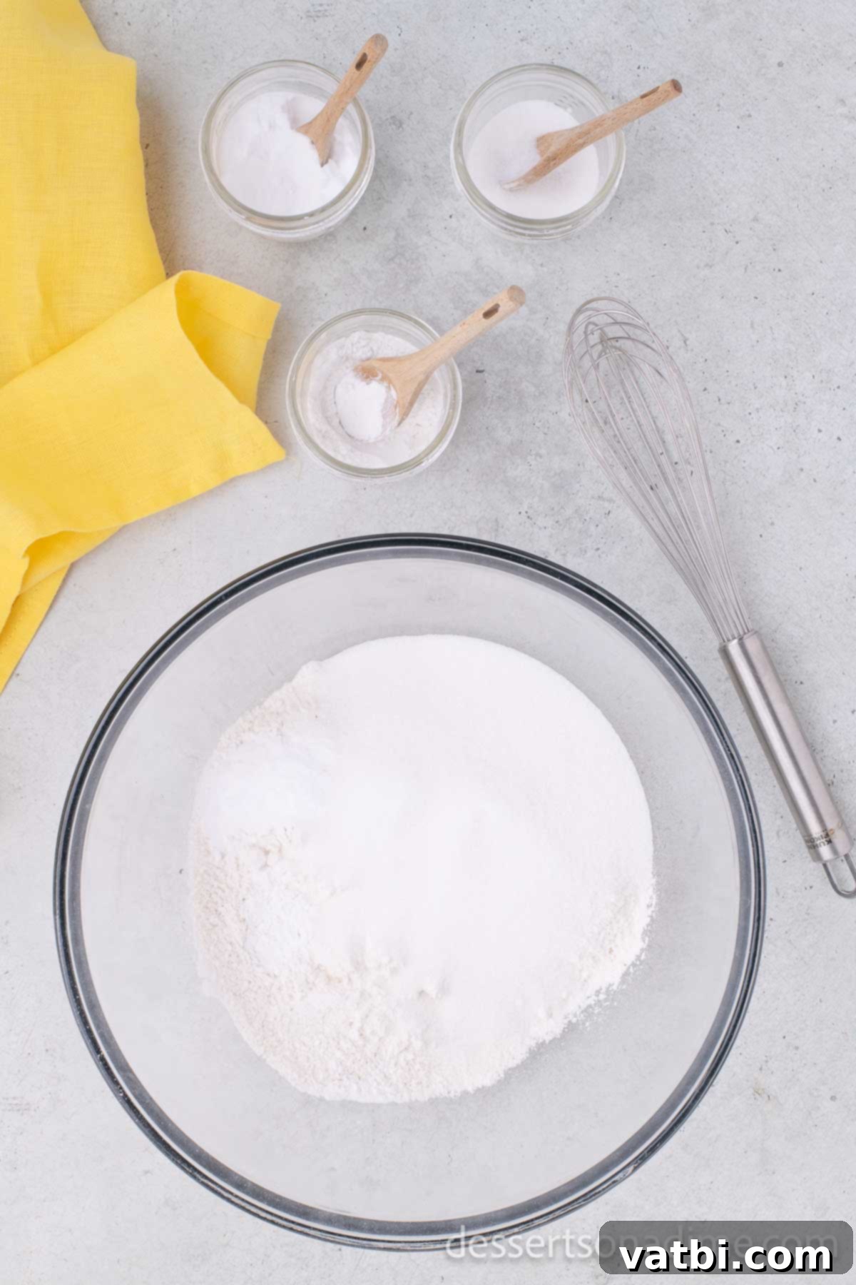 Wildly Delicious Banana Cake 4 A large mixing bowl containing the dry ingredients (flour, sugar, baking soda, baking powder, salt) waiting to be whisked together.