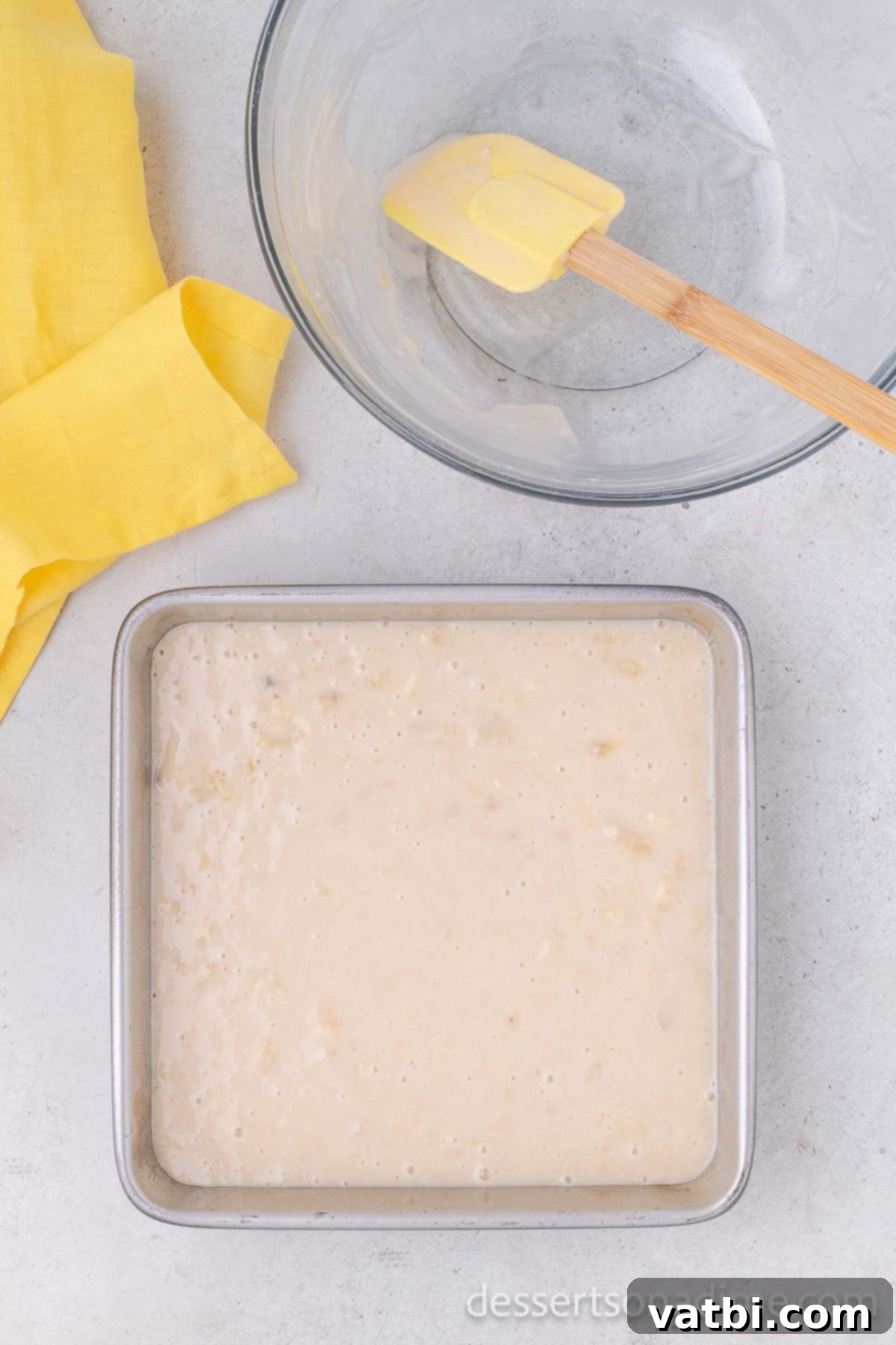 Wildly Delicious Banana Cake 8 Smooth cake batter being carefully poured into the prepared 8x8 inch baking pan, ready for the oven.