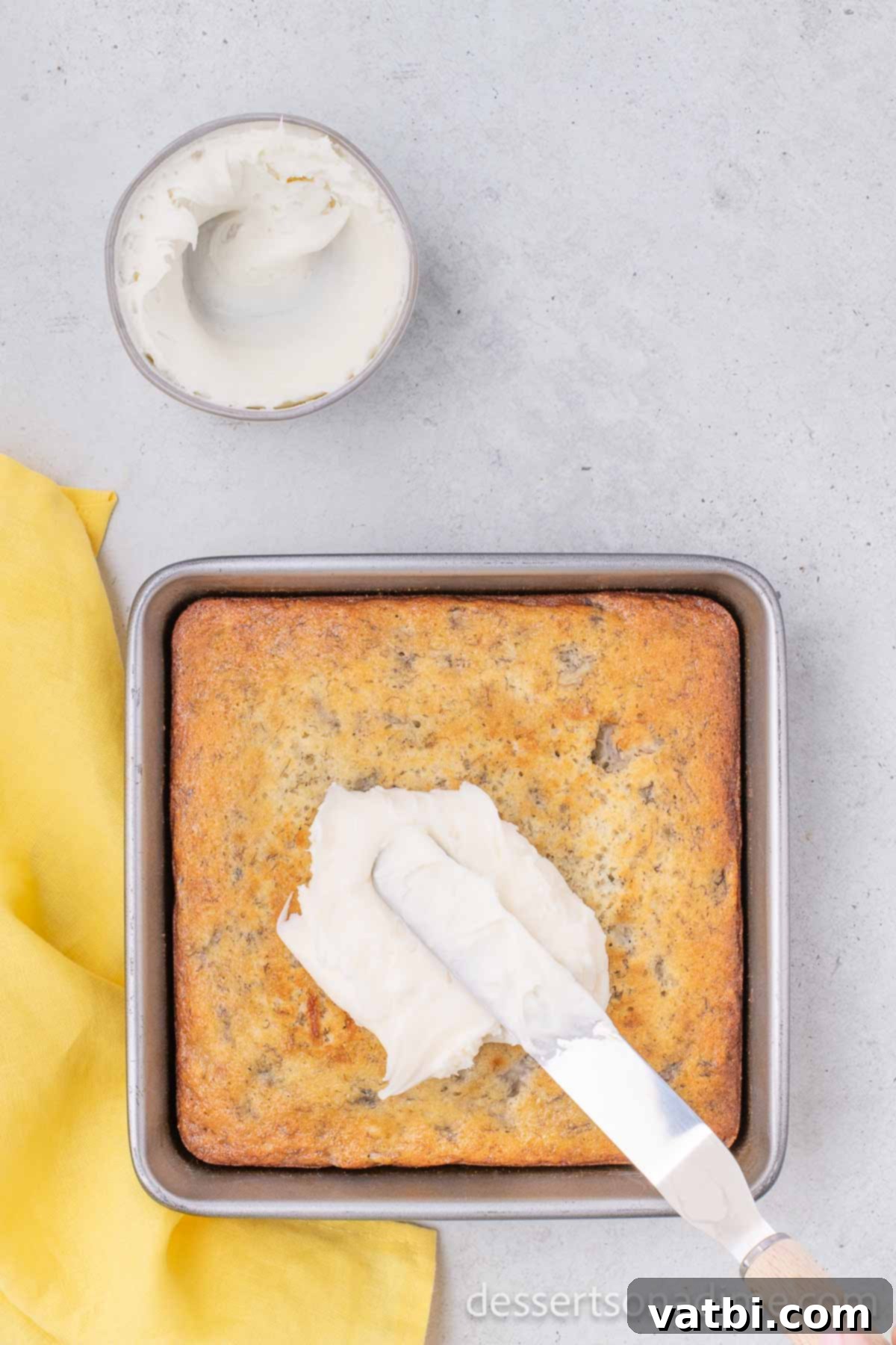 Wildly Delicious Banana Cake 9 The baked Crazy Banana Cake, golden brown and perfectly risen, cooling in the pan before being frosted with a creamy icing.