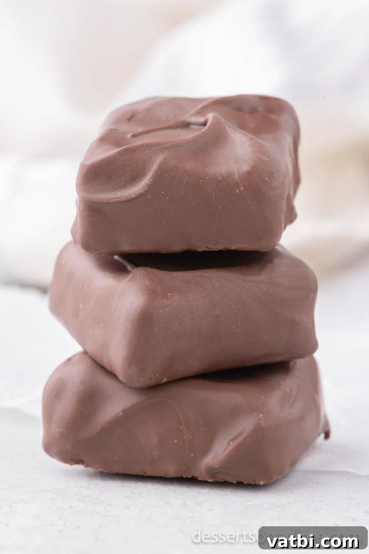 Cool Whip candy stacked artfully, showing the texture and chocolate coating.