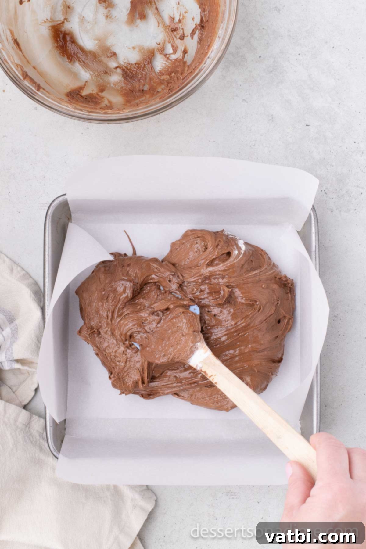 Chocolate and Cool Whip mixture poured into the parchment-lined pan.