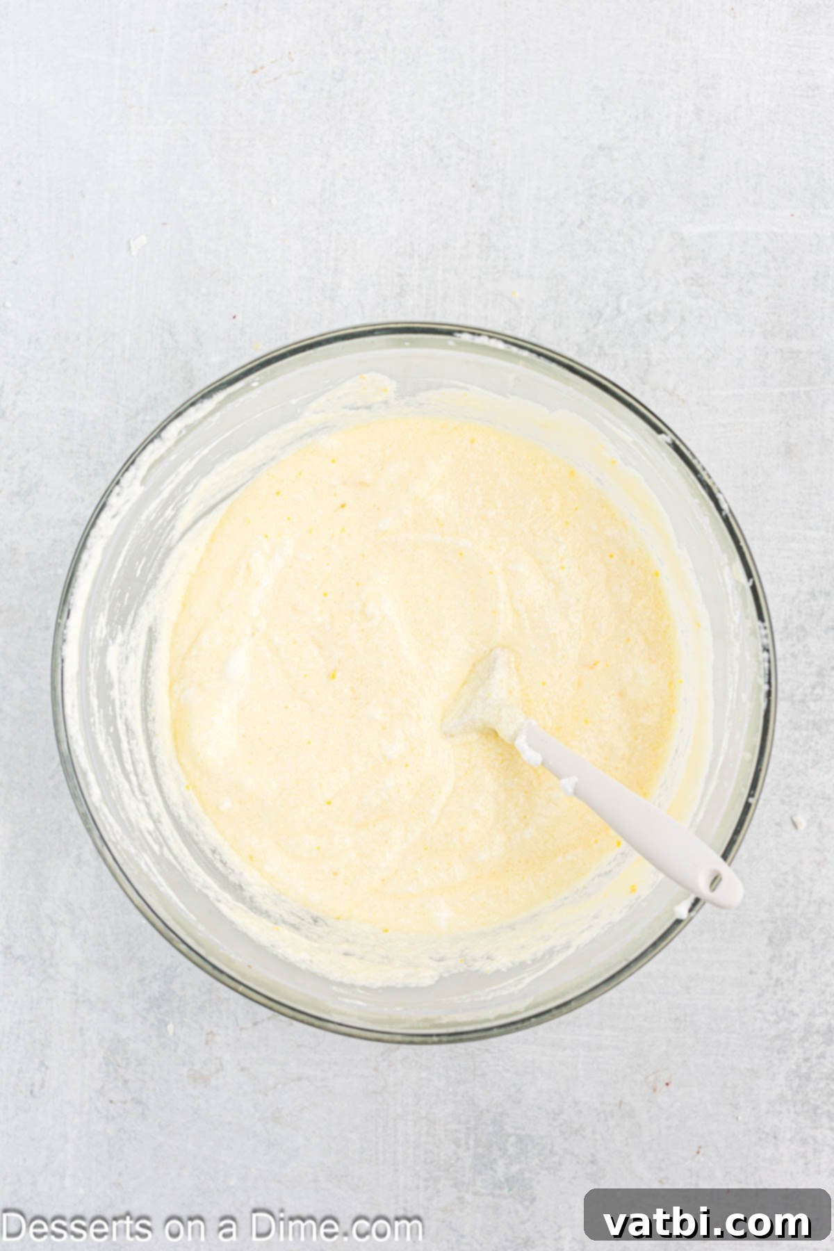 Zesty Lemon Pudding Cake 7 Egg whites being beaten to soft peaks in a separate bowl with an electric mixer.