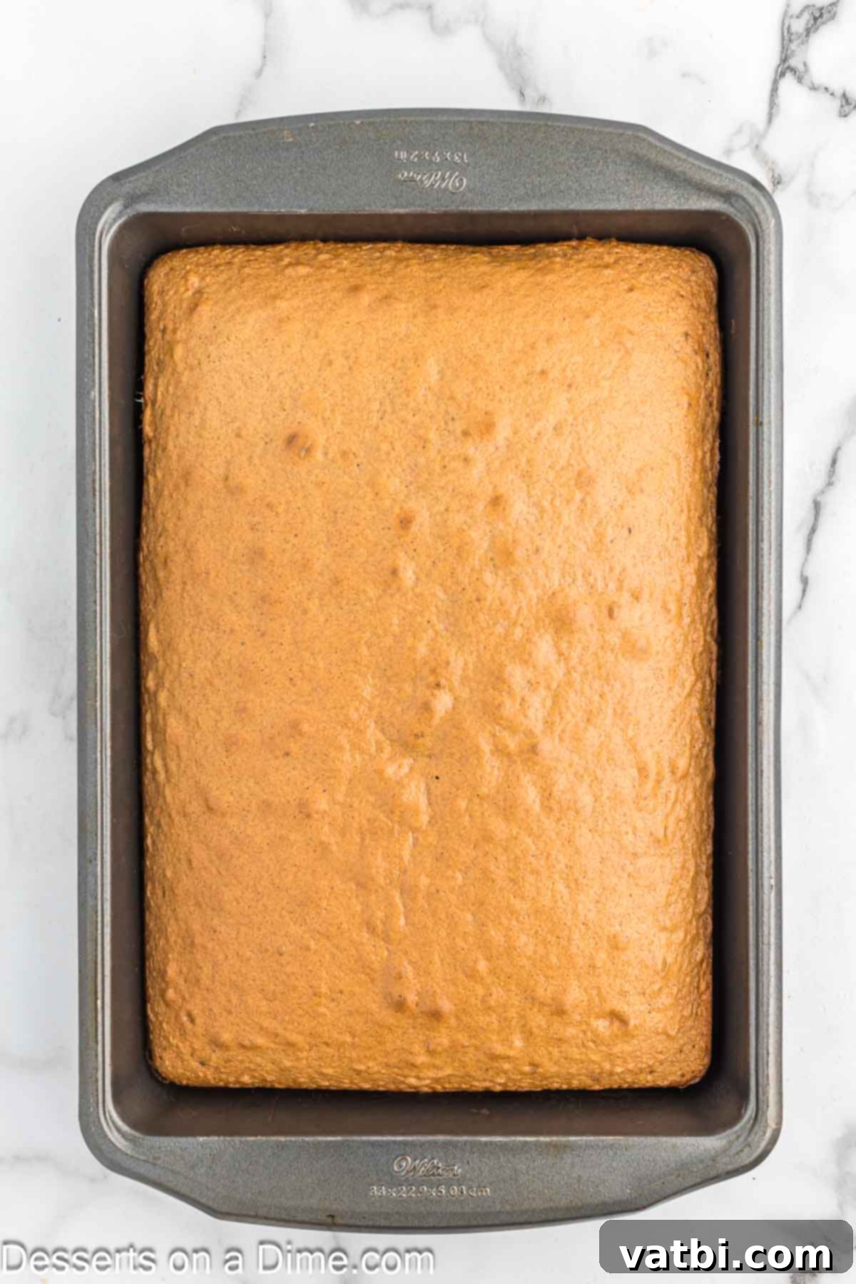 Spiced Carrot Cake Bites 4 Freshly baked carrot cake cooling in a baking pan, ready to be crumbled.