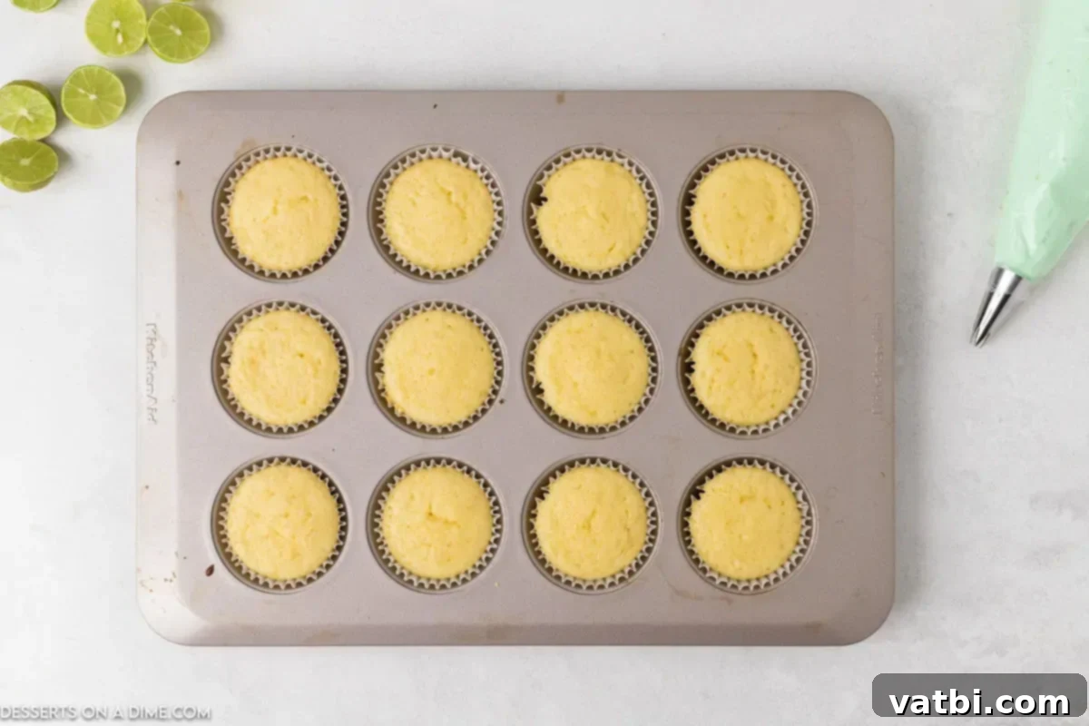 Zesty Key Lime Cupcakes 3 Cupcakes in pan baked and cooling.