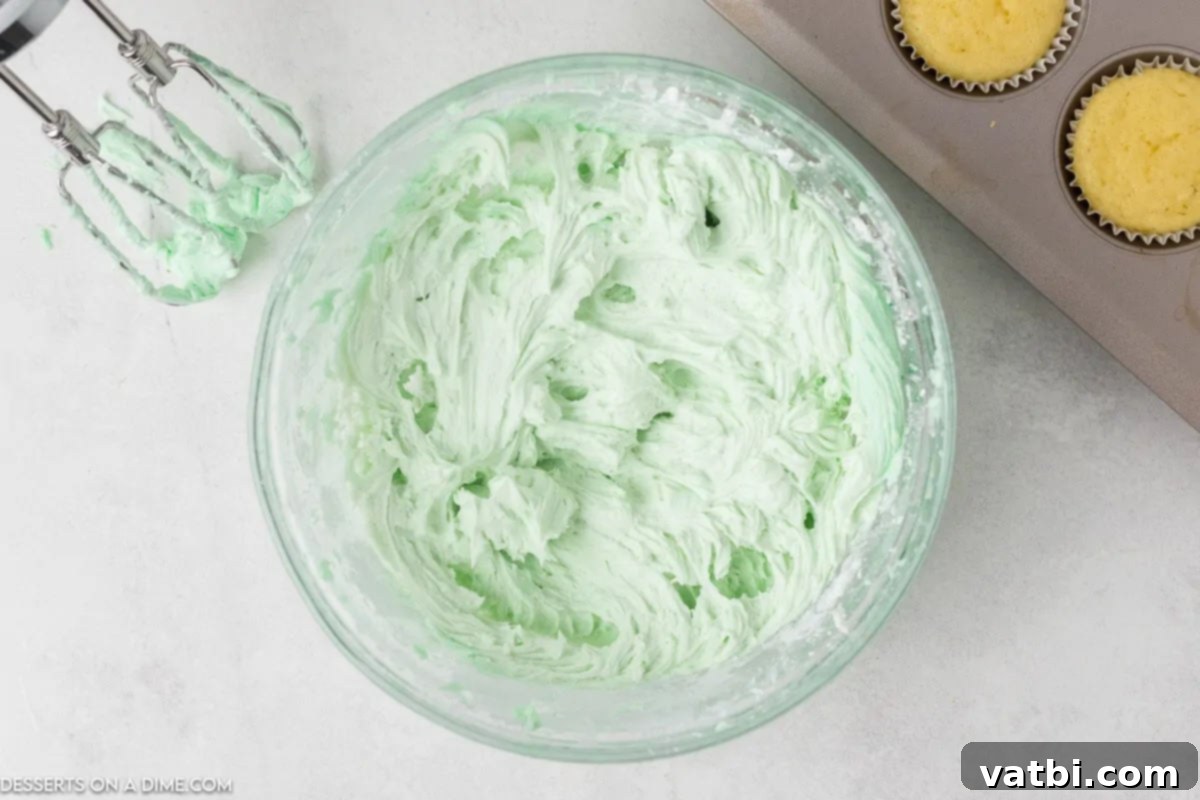 Zesty Key Lime Cupcakes 5 Food coloring and lime juice combined into mixture.