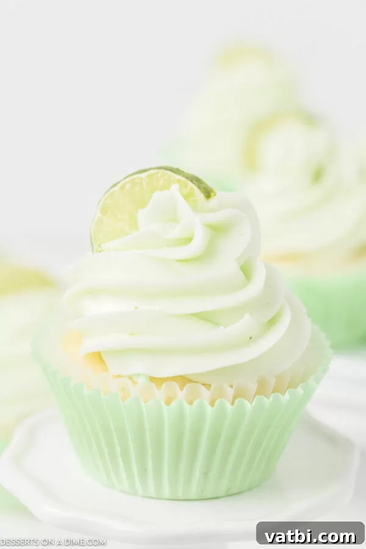 Sweet and tart key lime cupcakes make the best treat. Fans of key lime pie will love this recipe and the icing makes it even better. Try it! Key Lime Cupcakes topped with frosting a slice of lime