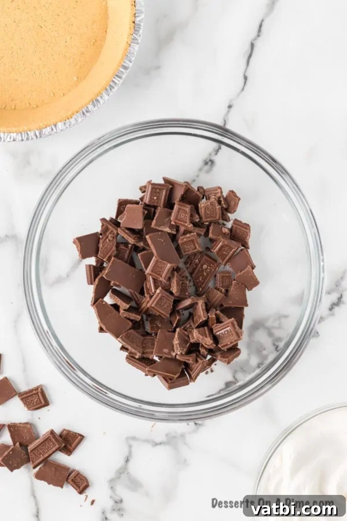 Chopped Hershey's Pieces in a bowl, perfectly broken for even melting.