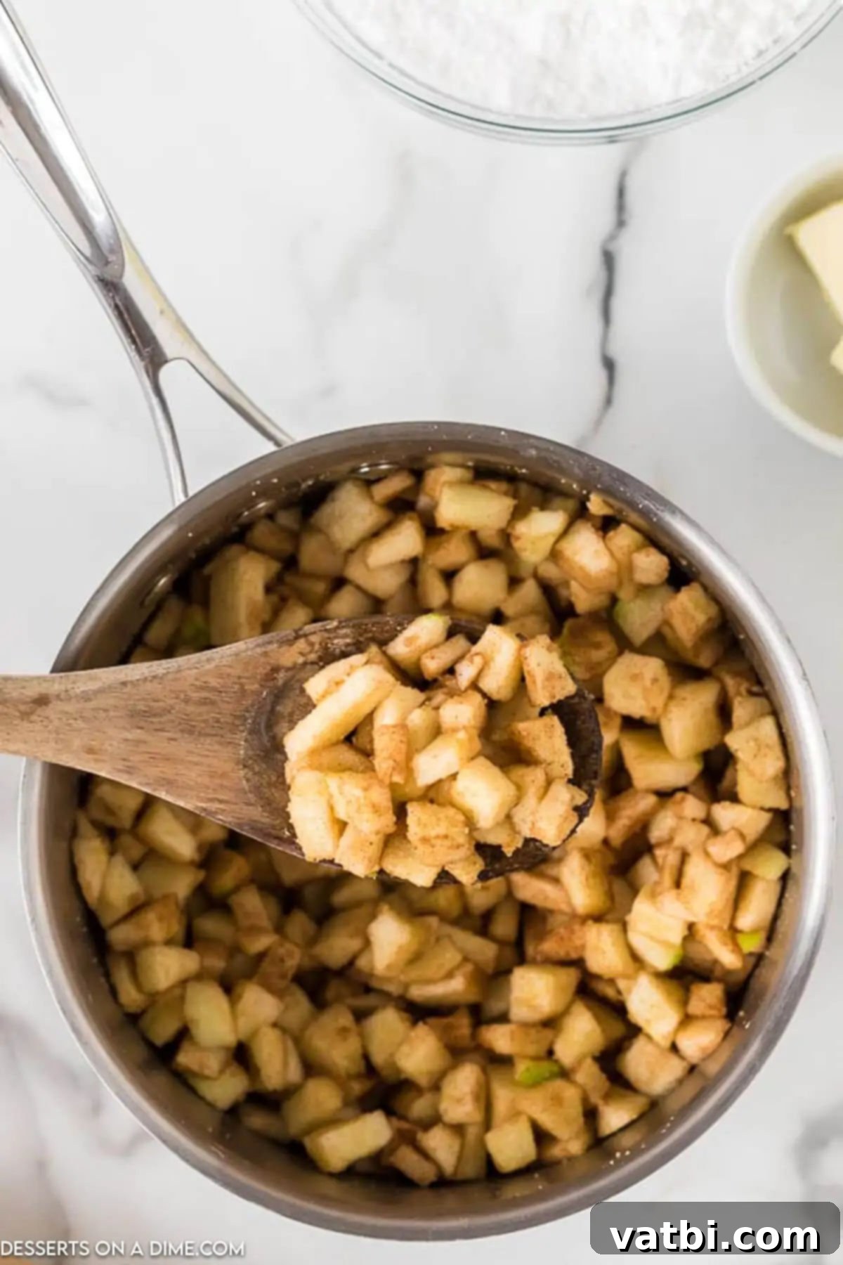 Golden Fried Apple Pockets 4 Saucepan with apples and seasoning.