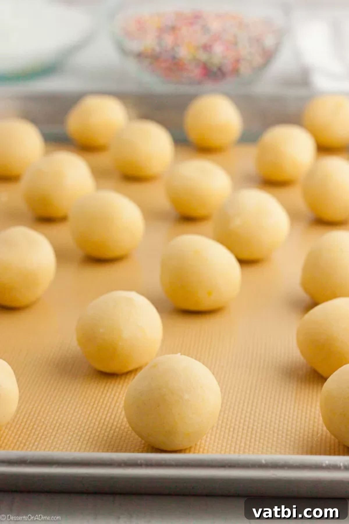Classic Italian Cookie Delights 4 Cookie dough balls on baking sheet.