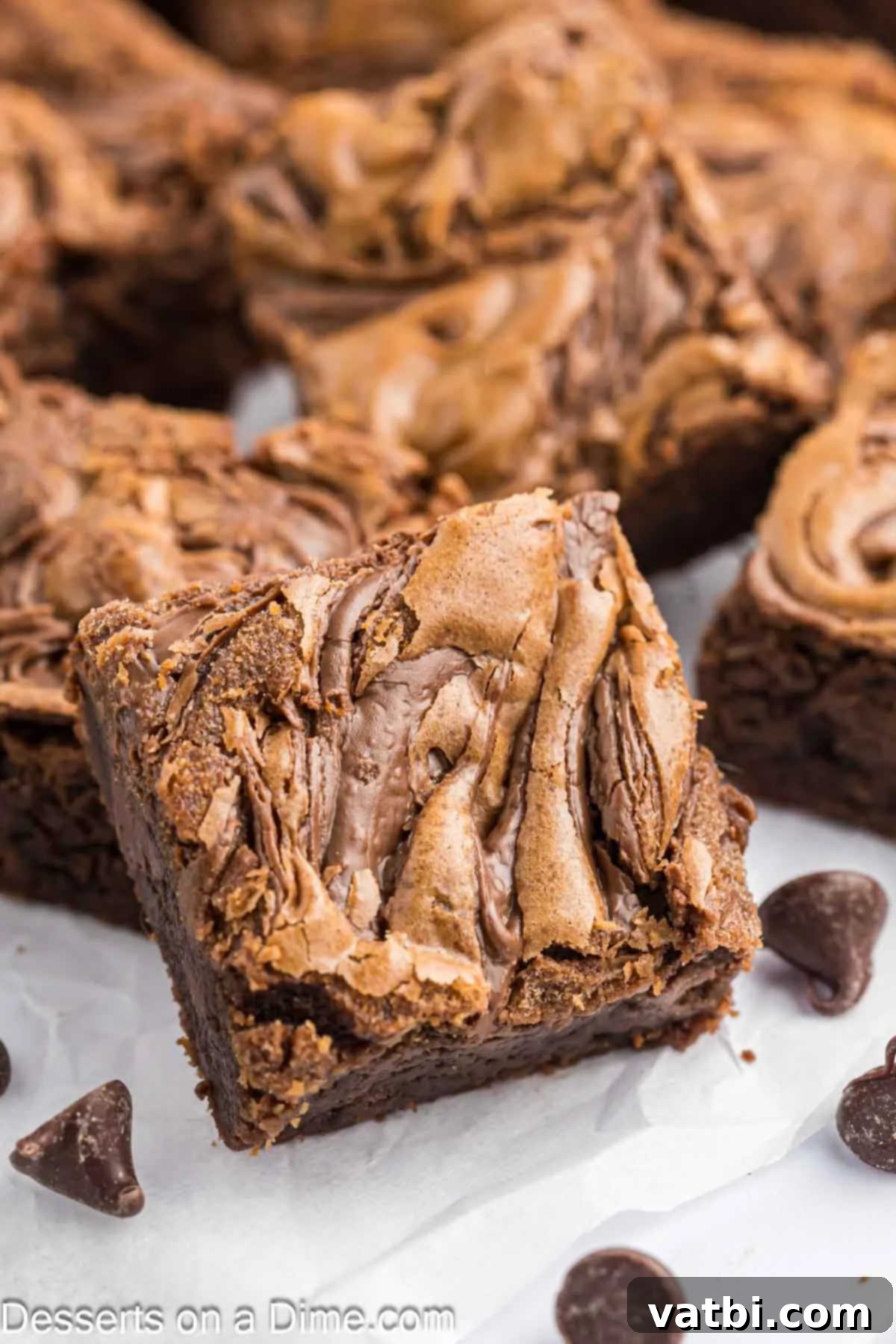 Fudgy Nutella Brownies 2 Fudgy Nutella brownies cut into perfect squares, showcasing the rich chocolate and hazelnut swirl for a delightful dessert.