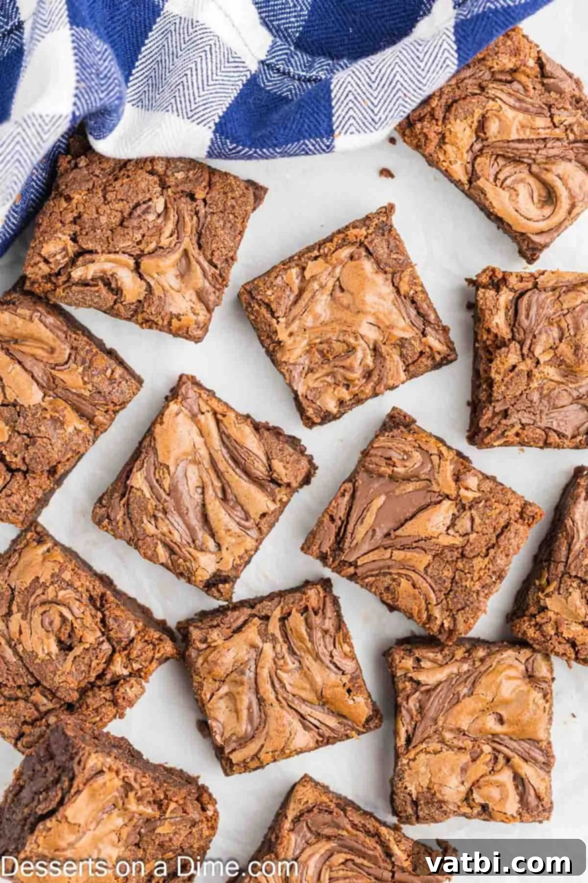 Fudgy Nutella Brownies 12 Perfectly sliced Nutella brownies, showcasing their fudgy texture and beautiful hazelnut swirl, ready to be served.