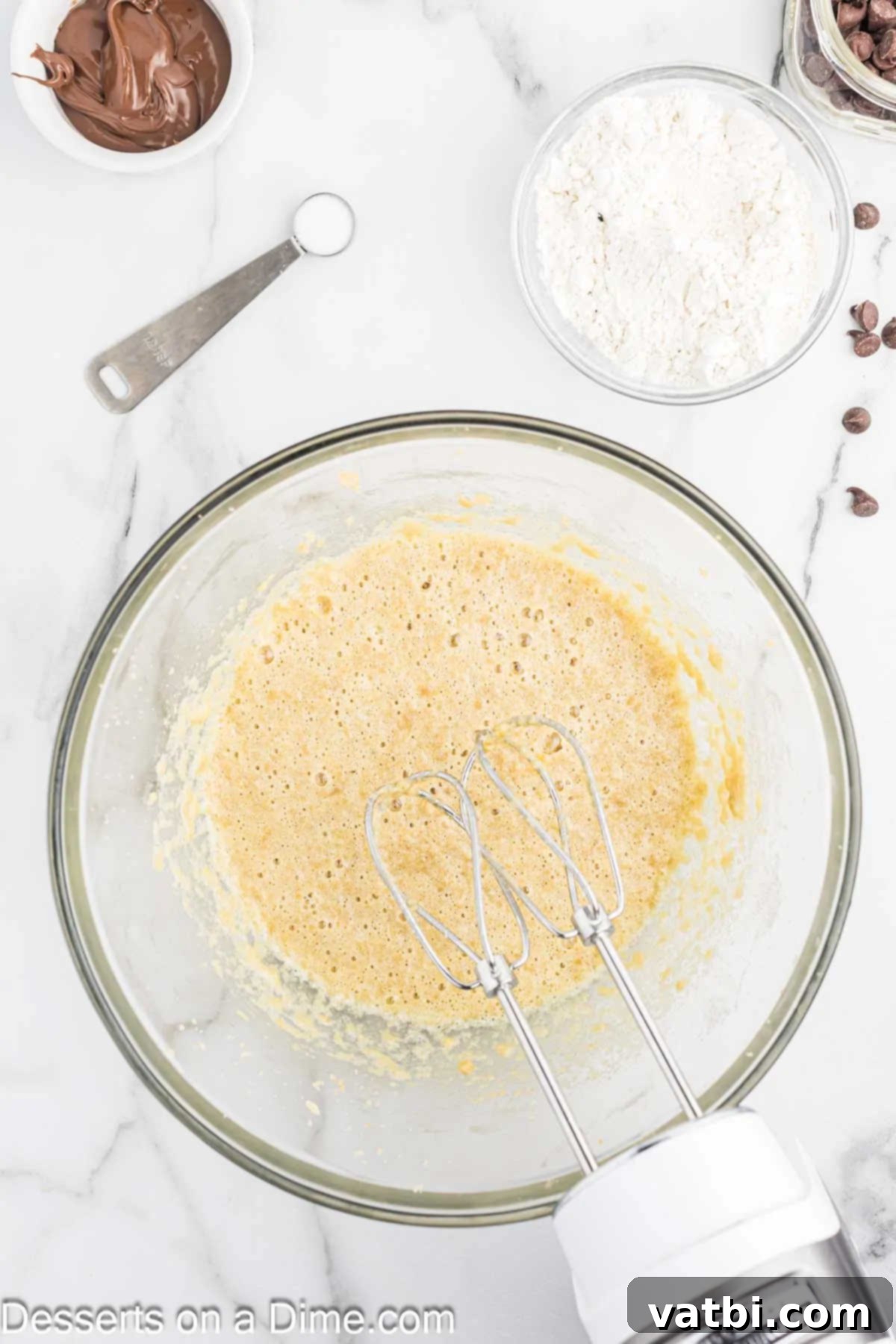 Fudgy Nutella Brownies 5 Room temperature eggs and vanilla extract added to the creamed butter and sugar mixture in a mixing bowl.