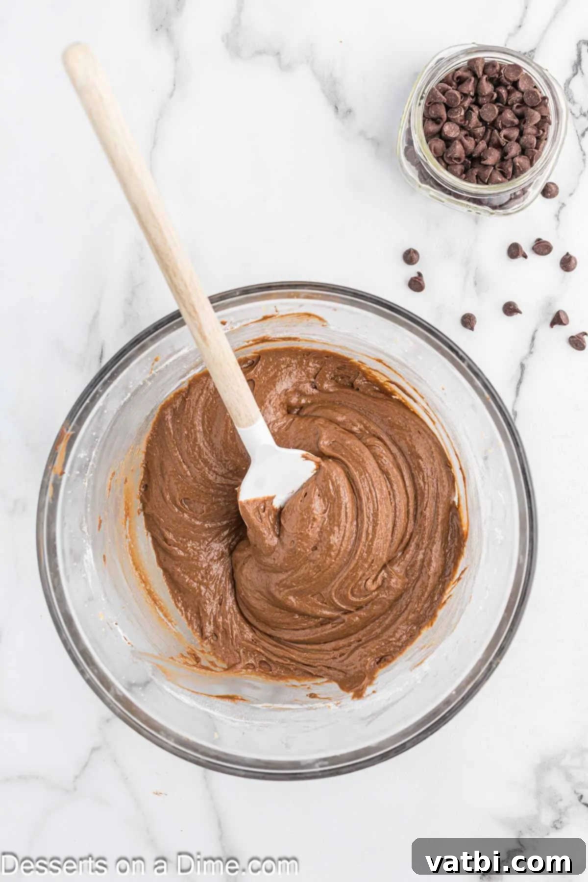 Fudgy Nutella Brownies 6 Nutella and salt mixed into the brownie batter, creating a smooth, rich chocolatey base in a bowl.