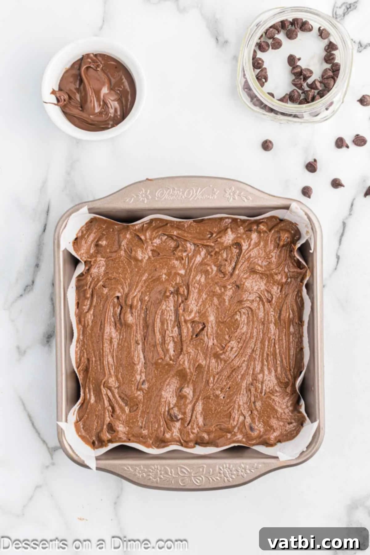 Fudgy Nutella Brownies 8 Rich brownie batter evenly spread into the parchment-lined baking pan, ready for the Nutella swirl.