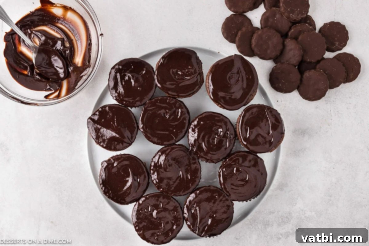 Cupcakes topped with ganache on a platter. 