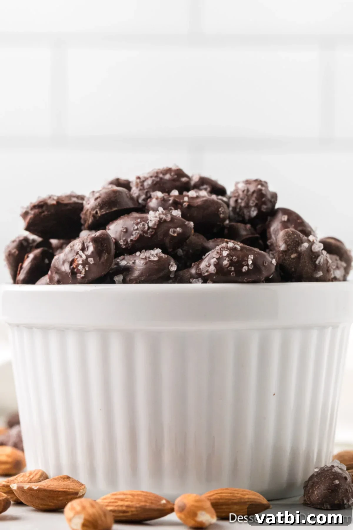Midnight Almond Delights 2 Chocolate covered almonds in a bowl.