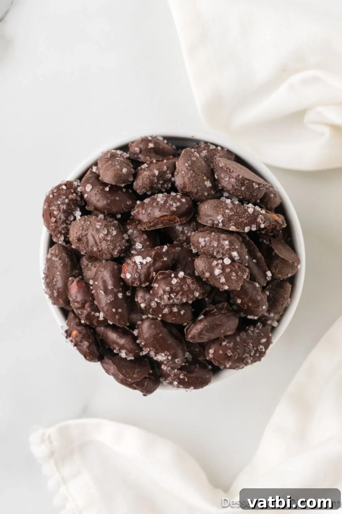 Midnight Almond Delights 10 Chocolate covered almonds in a bowl.