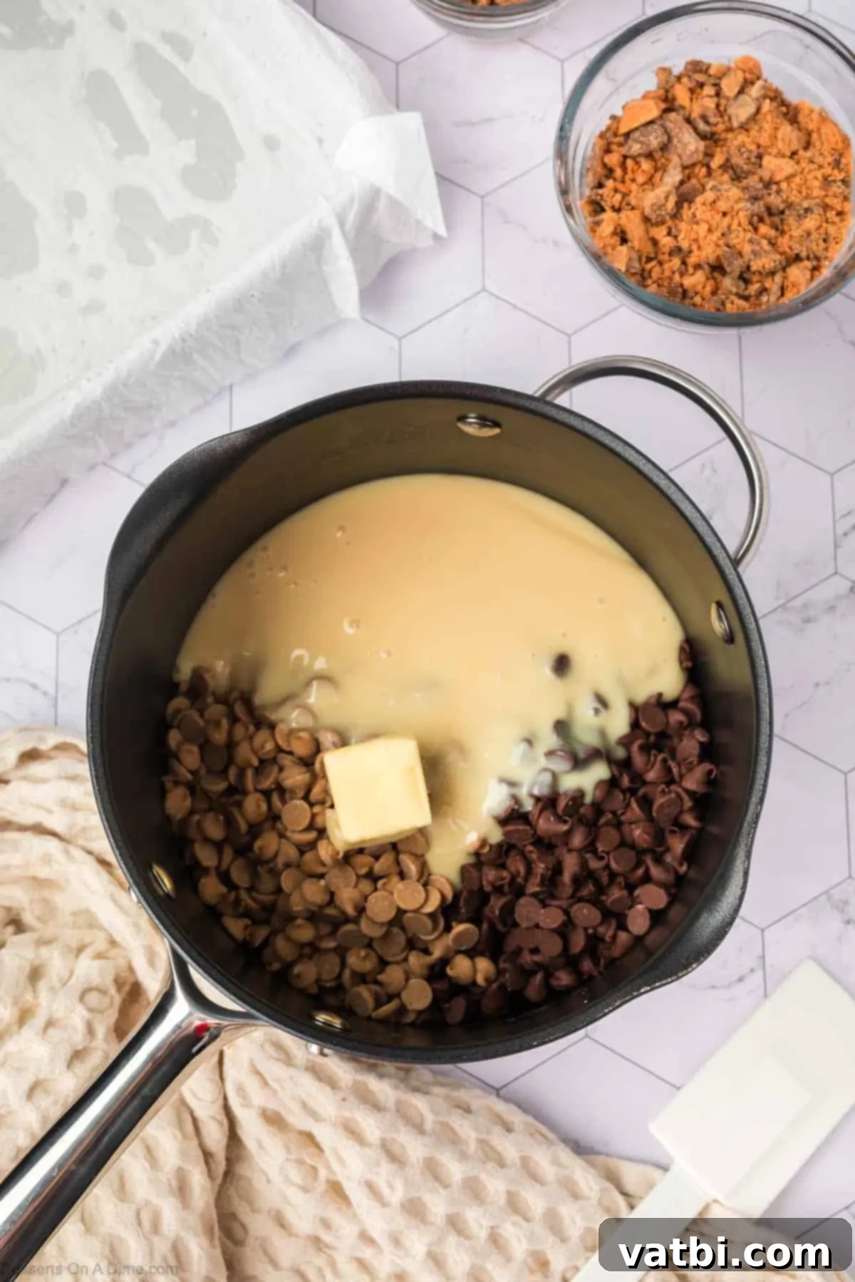 Chocolate chips and sweetened condensed milk combined in saucepan. 