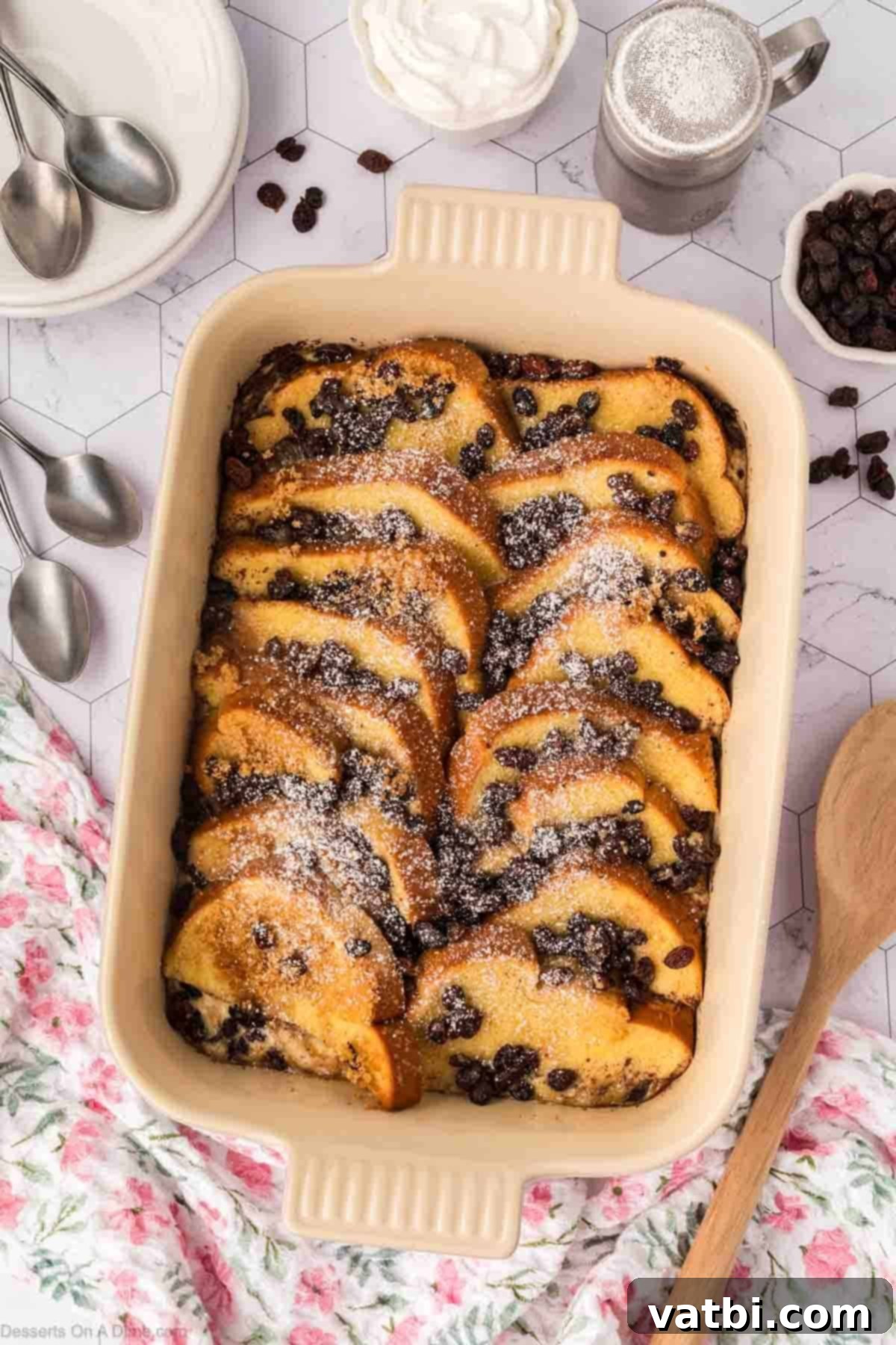 Freshly baked bread pudding dusted with powdered sugar, ready to be served.
