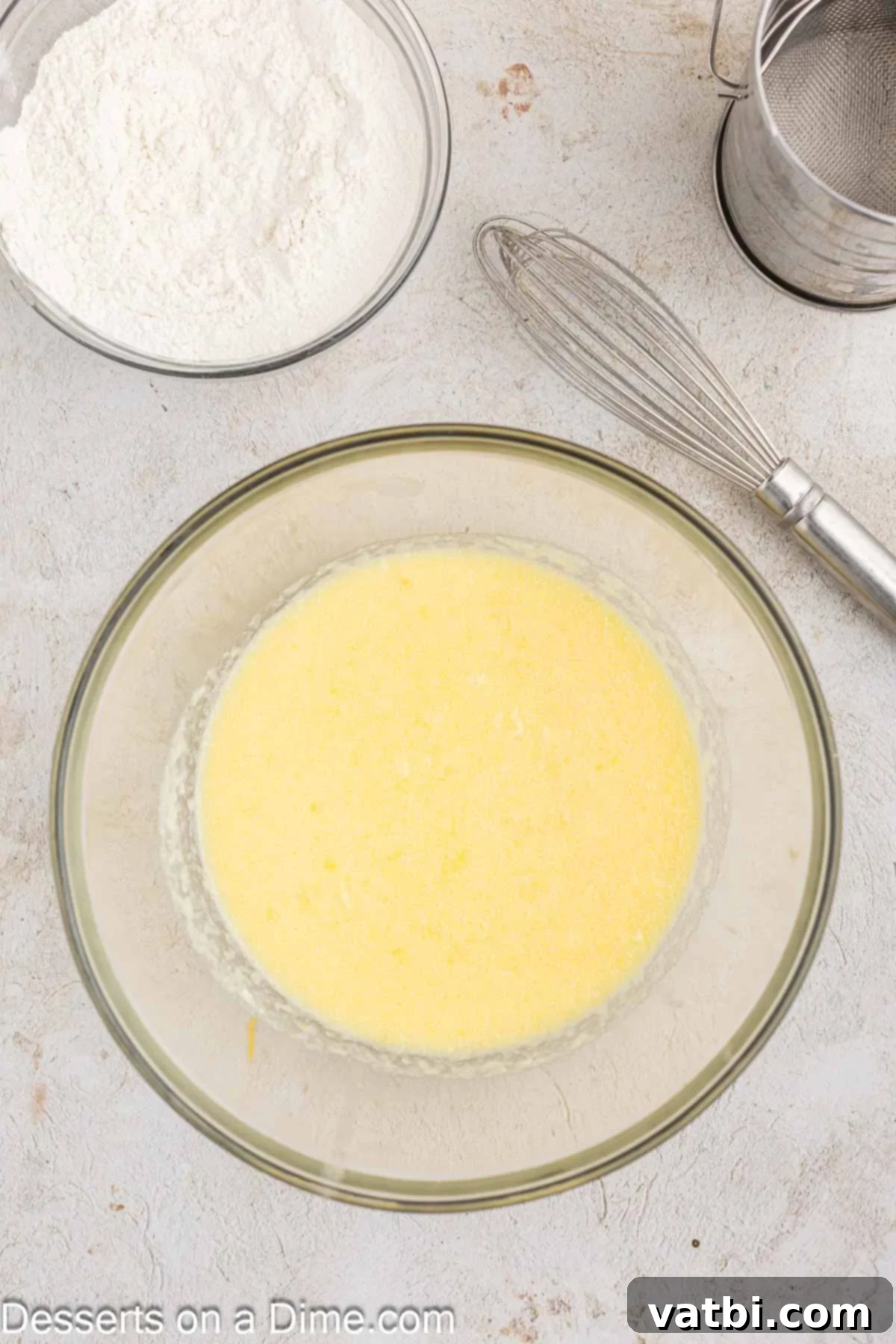 Zesty Orange Cranberry Loaf 4 Orange cranberry bread batter in a large mixing bowl, showing the wet ingredients combined smoothly.