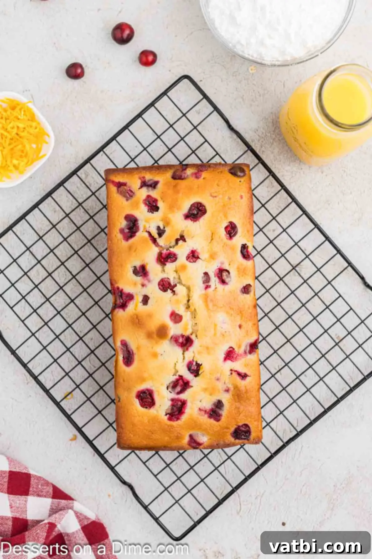 Zesty Orange Cranberry Loaf 8 Freshly baked orange cranberry bread cooling on a wire rack.