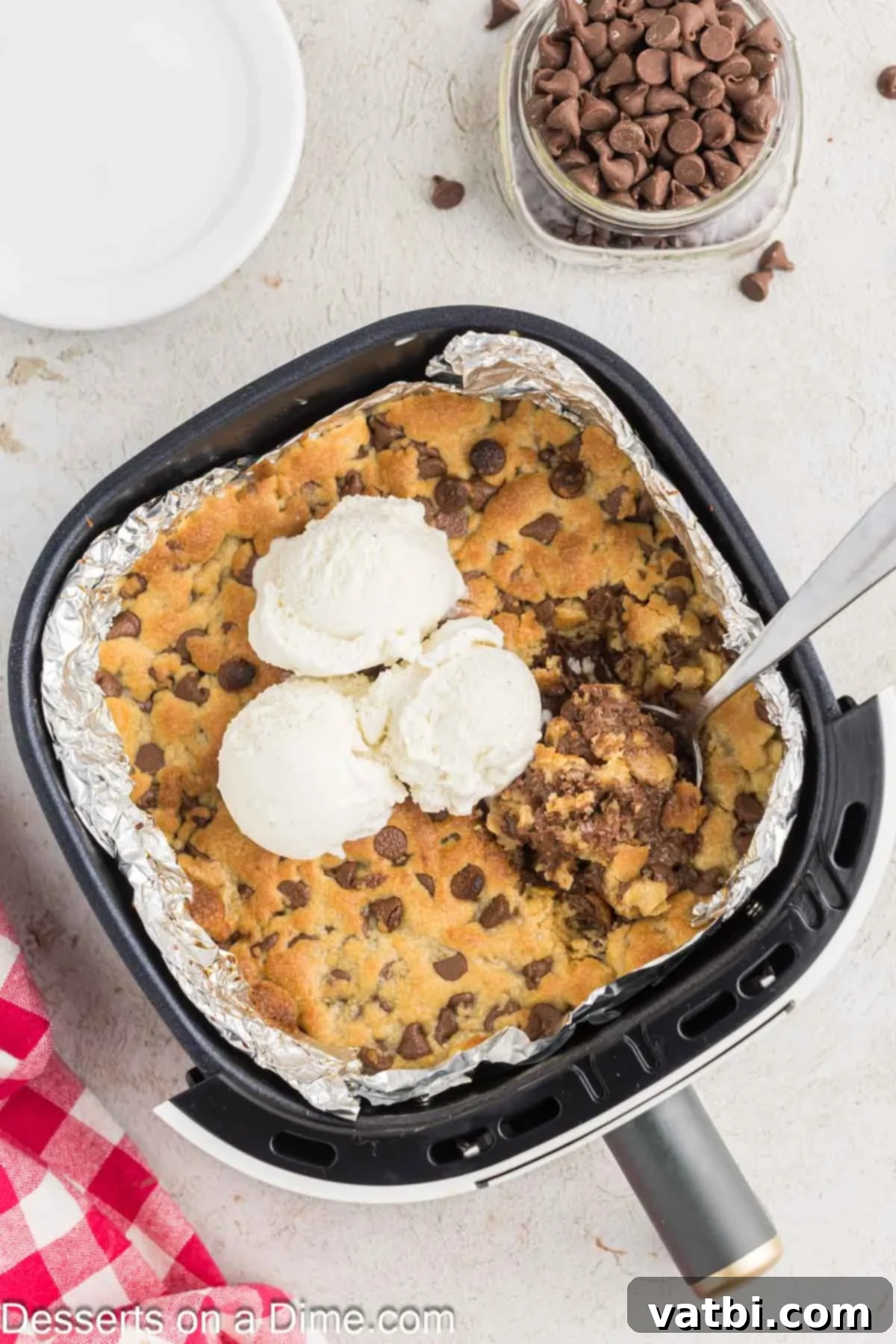 Close-up of an Air Fryer Pizookie topped with melting ice cream, ready to be eaten.
