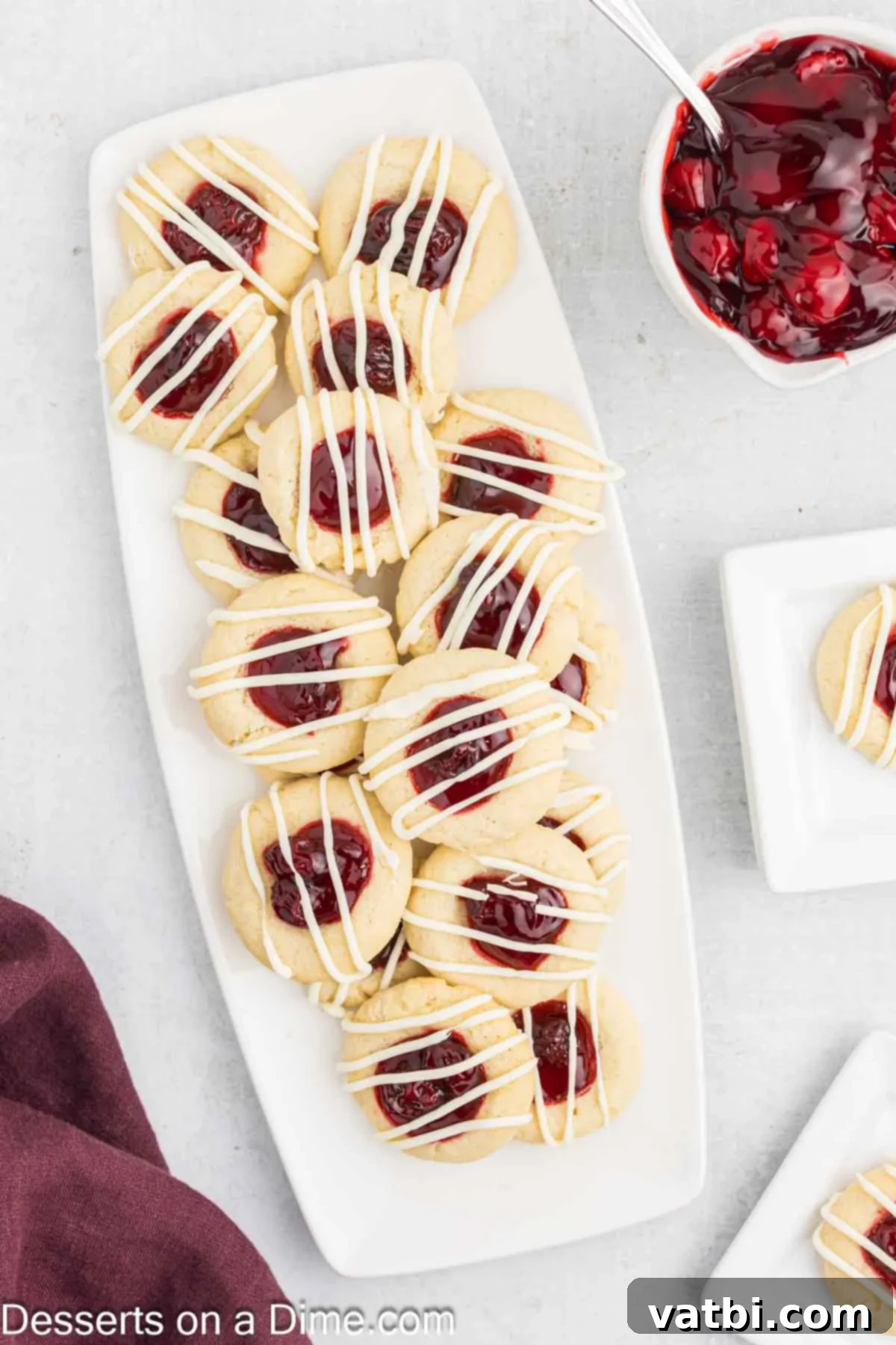 Cherry Thumbprint cookies on a white tray.
