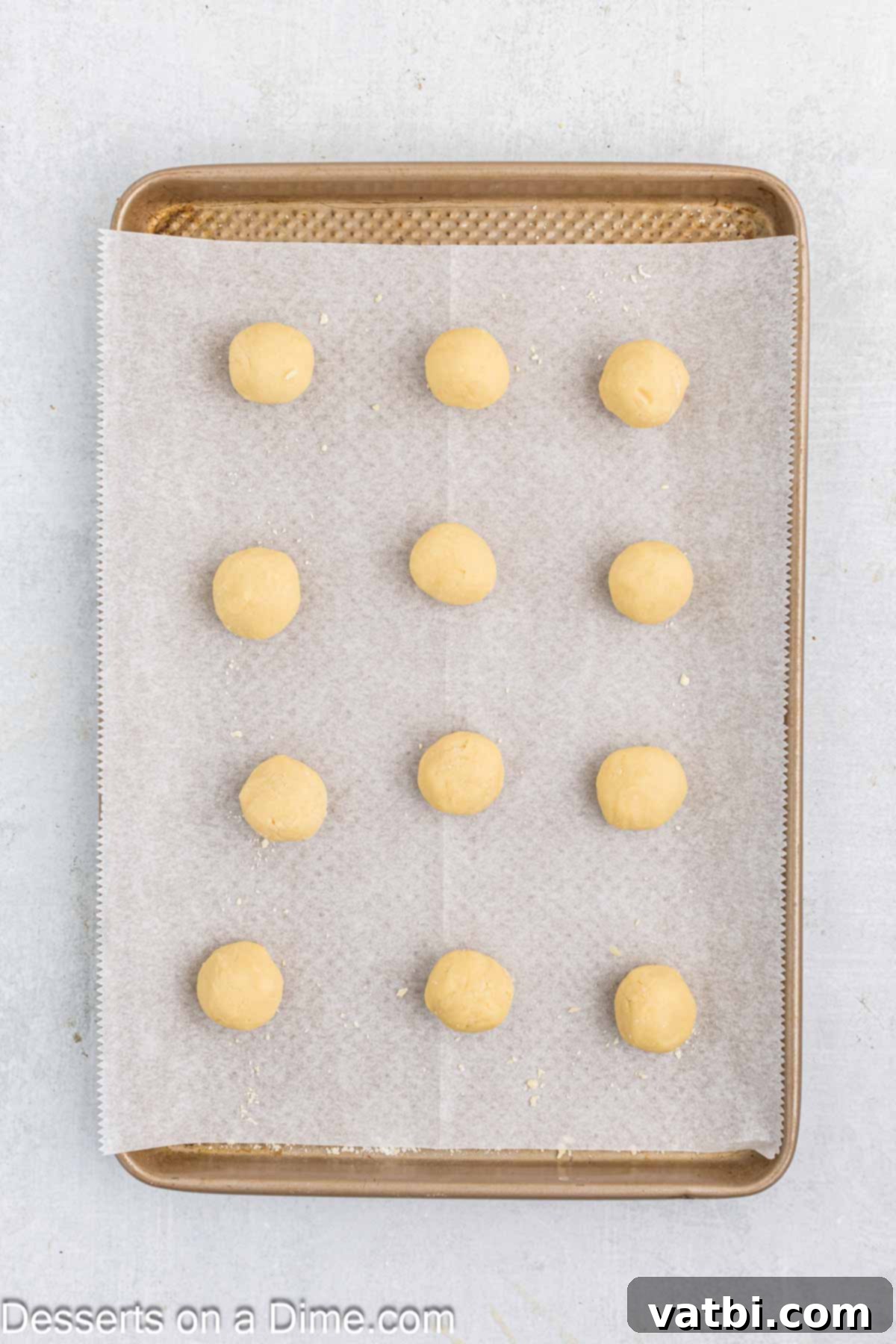 Dough shaped into balls on baking sheet.