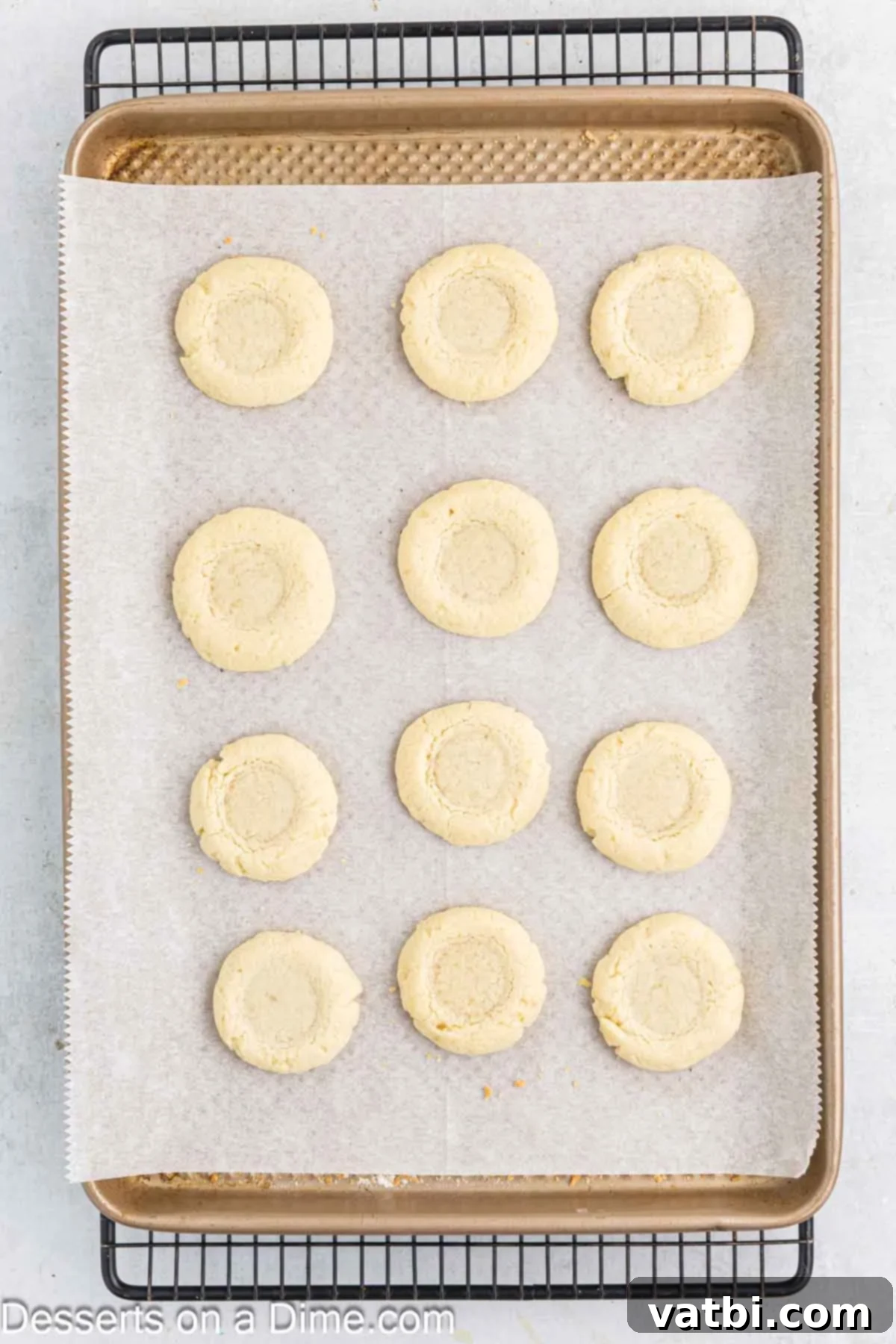 Cookies baked and cooling on cookie sheet.