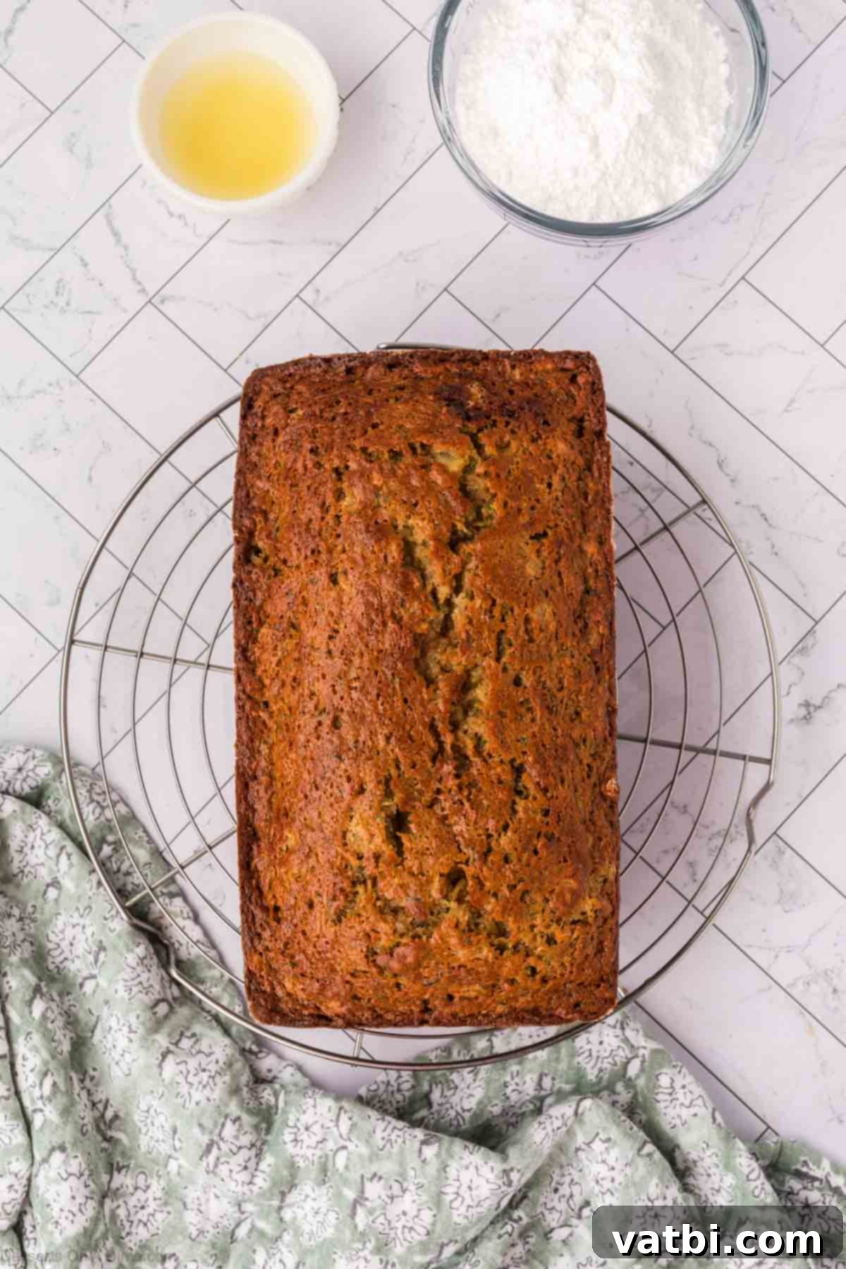 Baked zucchini bread cooling on a wire rack.