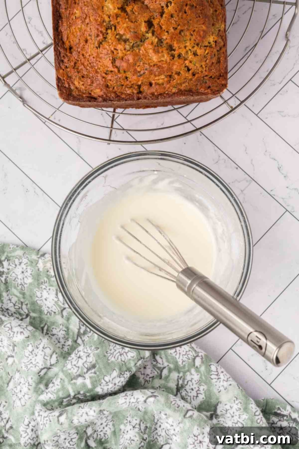 Glaze mixture in a bowl with a whisk.