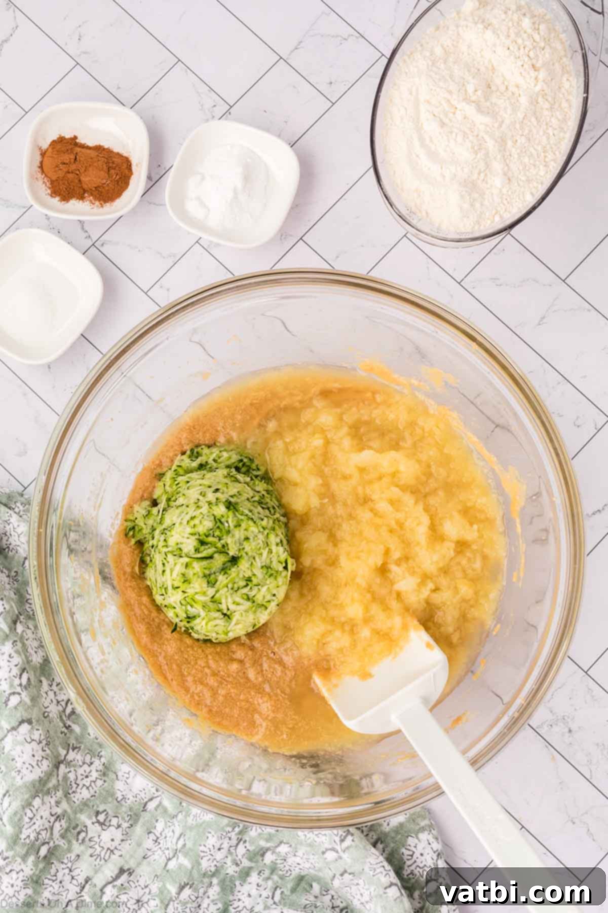Grated zucchini and crushed pineapple folded into the wet ingredients.