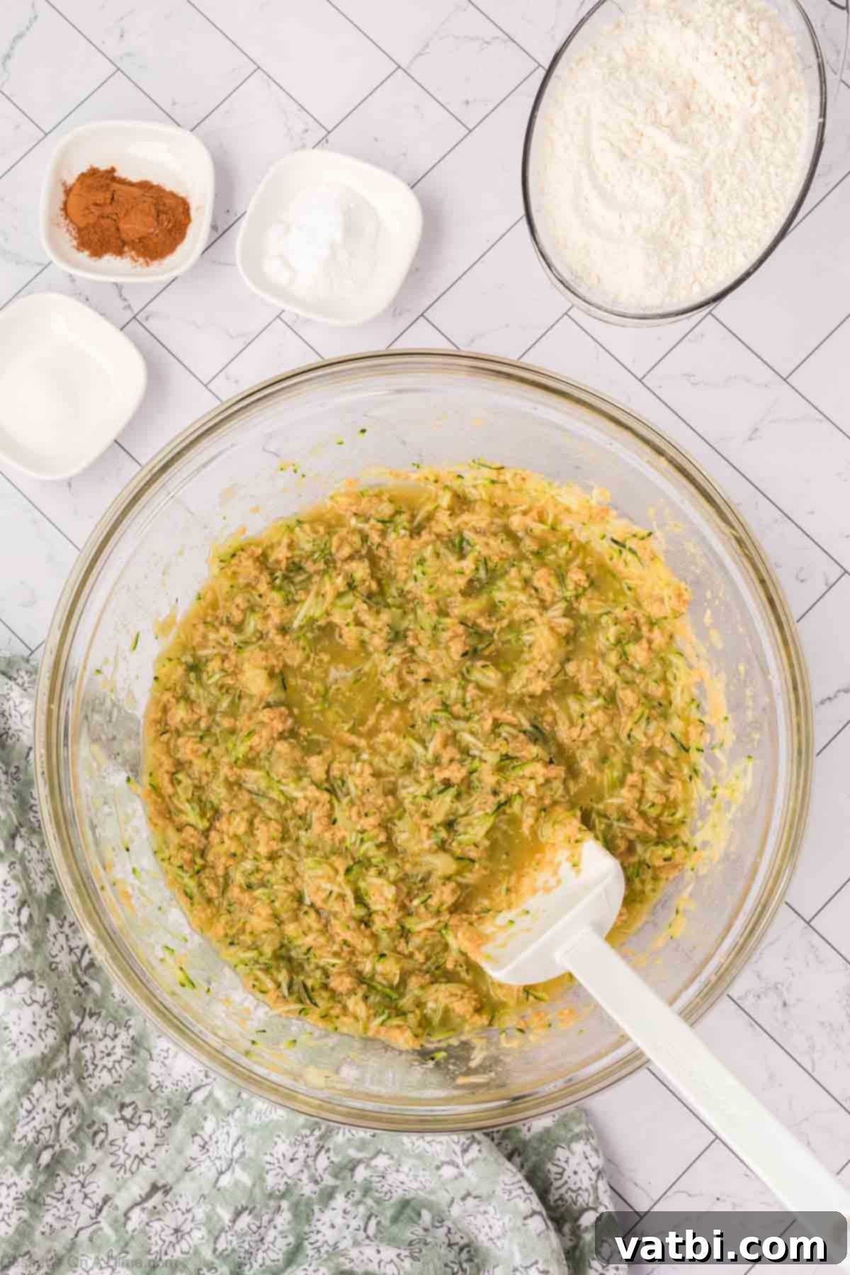 Combined batter with zucchini and pineapple distributed throughout.