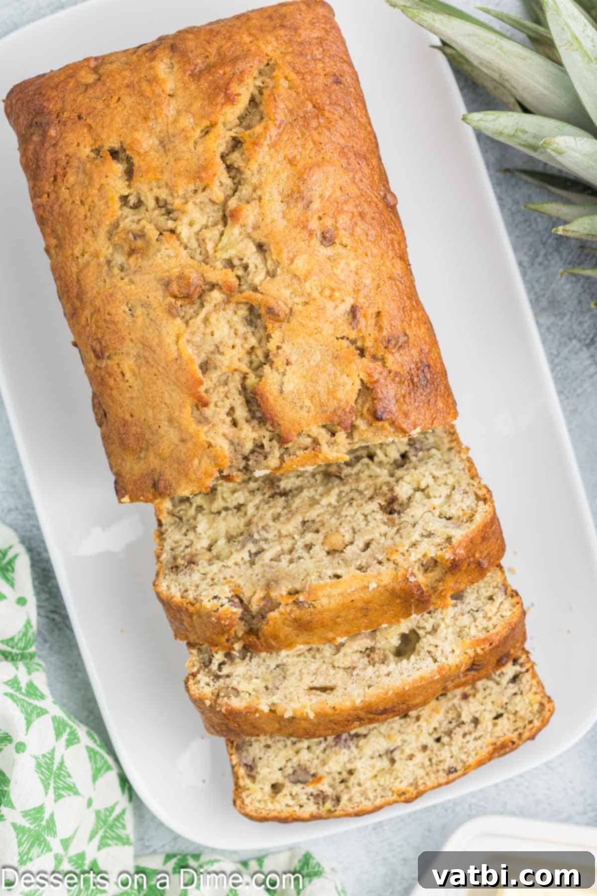 Tropical Sunshine Loaf 11 Delicious Banana Bread sliced on a platter, ready to be enjoyed.