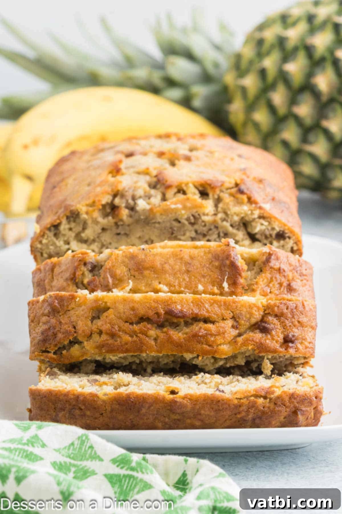 Tropical Sunshine Loaf 12 Perfectly sliced Banana Pineapple Bread displayed on a serving platter.
