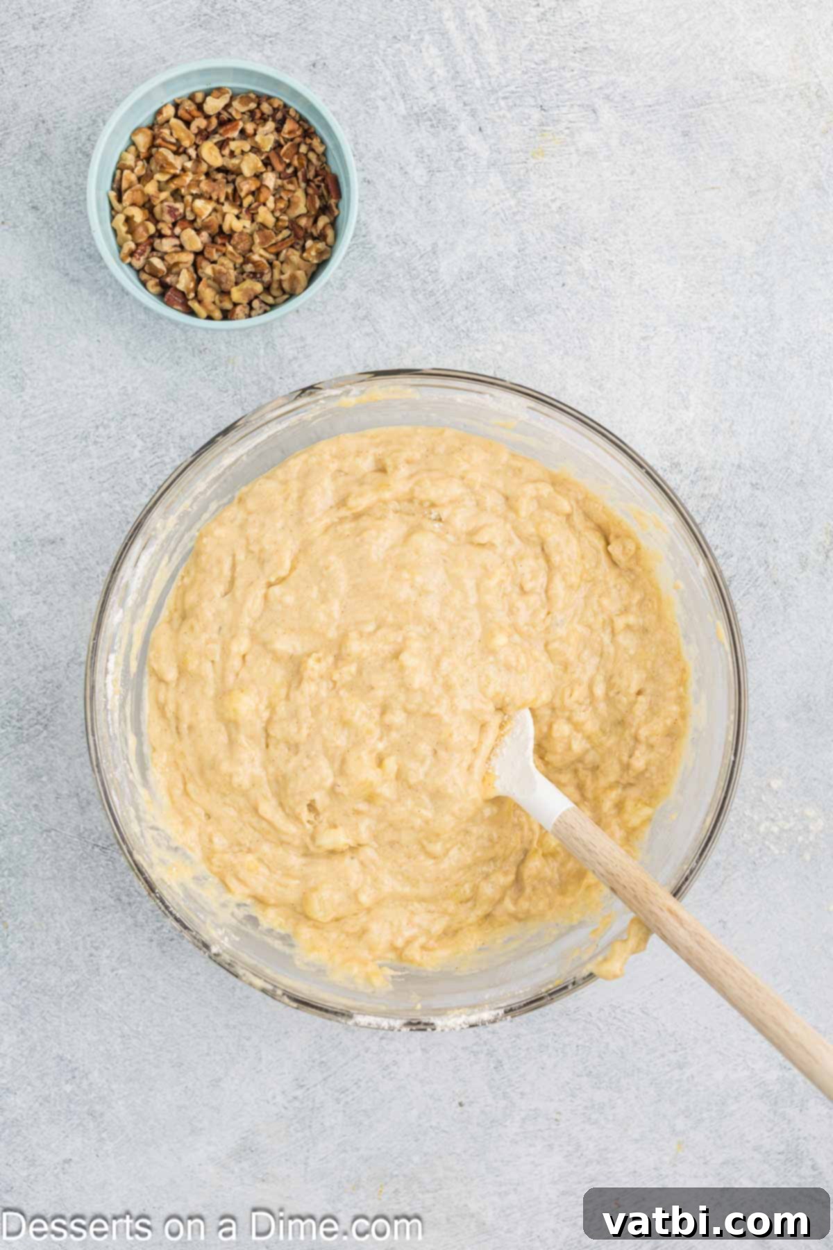 Tropical Sunshine Loaf 7 Mashed bananas being mixed into the wet batter, creating a rich and flavorful base.