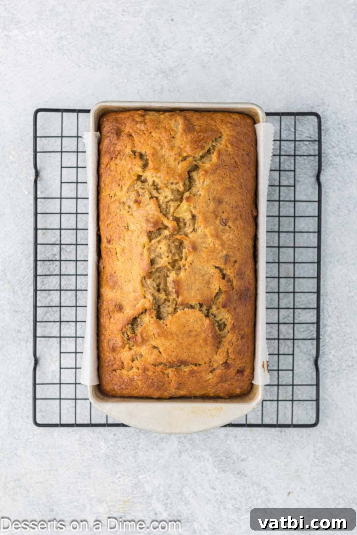 Tropical Sunshine Loaf 10 Banana Pineapple bread cooling on a wire rack after being baked to golden perfection.