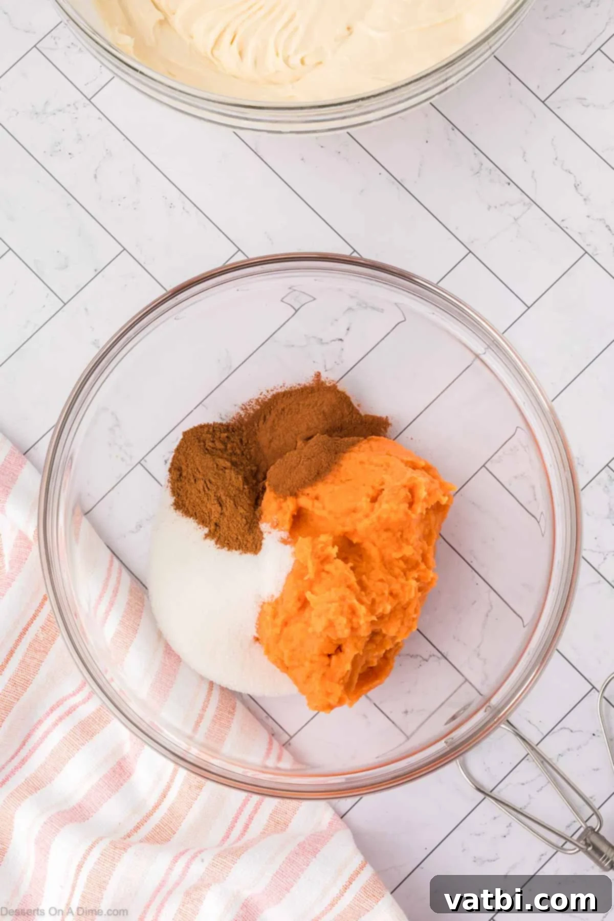 Sweet potato puree mixed with pumpkin pie spice, cinnamon, and sugar in a separate bowl.