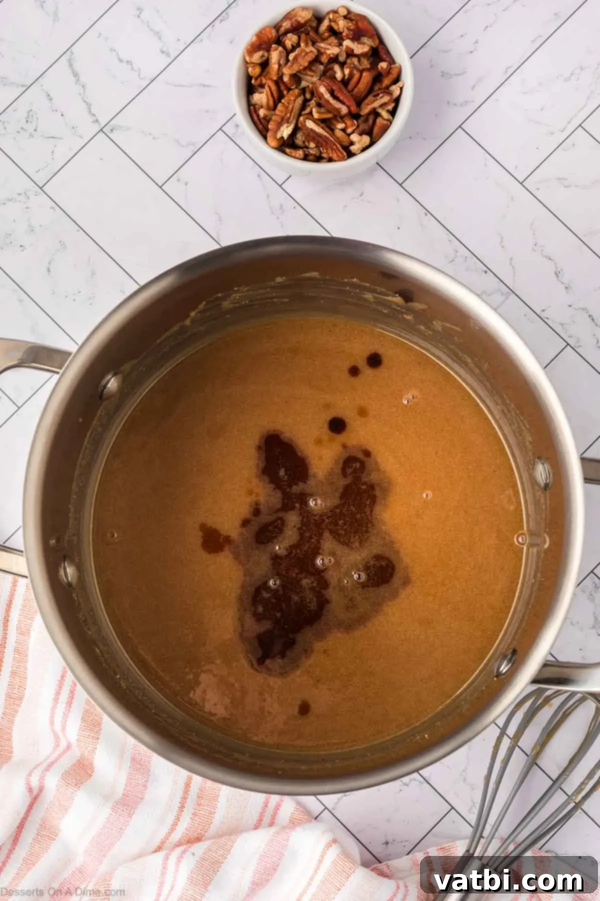 Ingredients for salted caramel topping (brown sugar, heavy cream, butter, salt, pumpkin pie spice) combined in a saucepan on the stove.