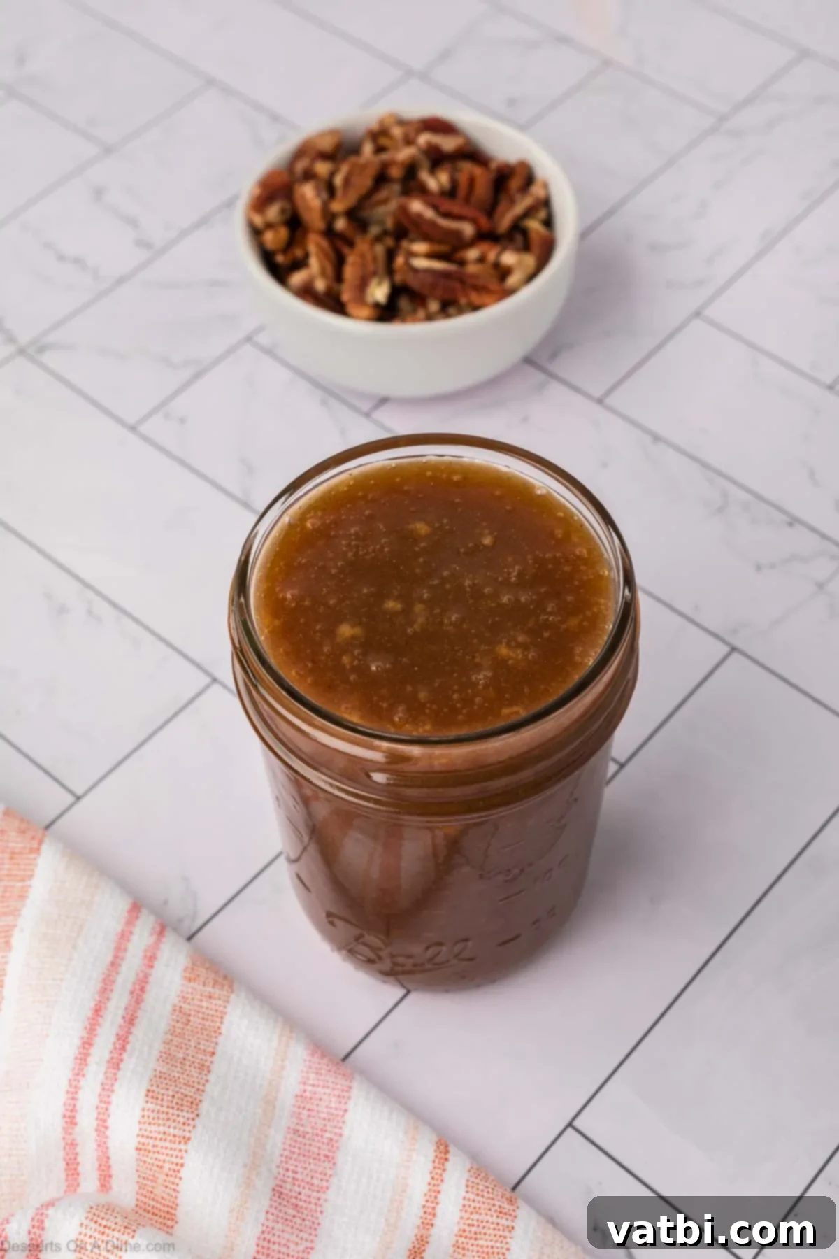 Freshly made salted caramel topping cooling in a glass jar.