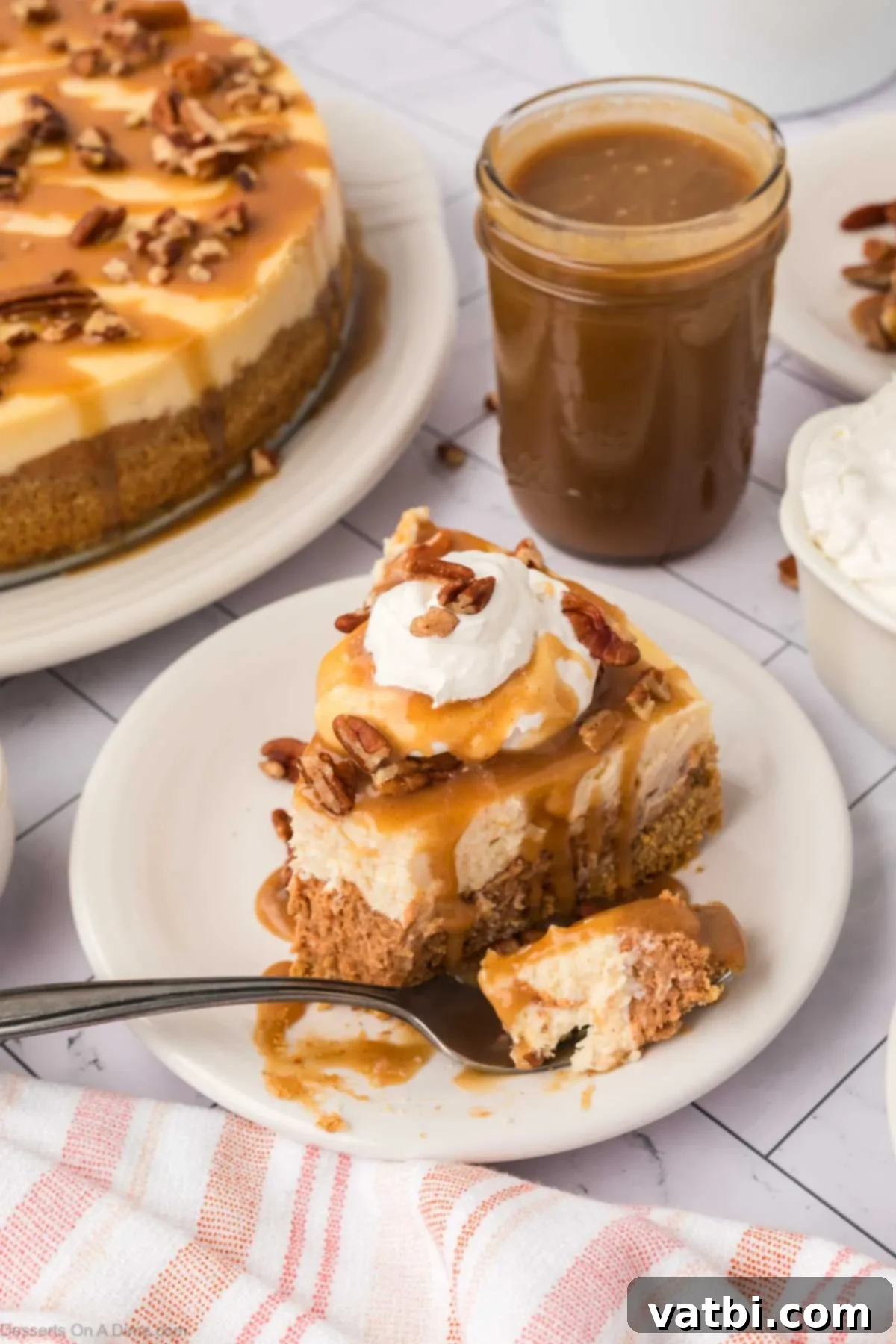 A pristine slice of sweet potato cheesecake, drizzled with caramel, elegantly plated on a white dish, ready to be enjoyed.