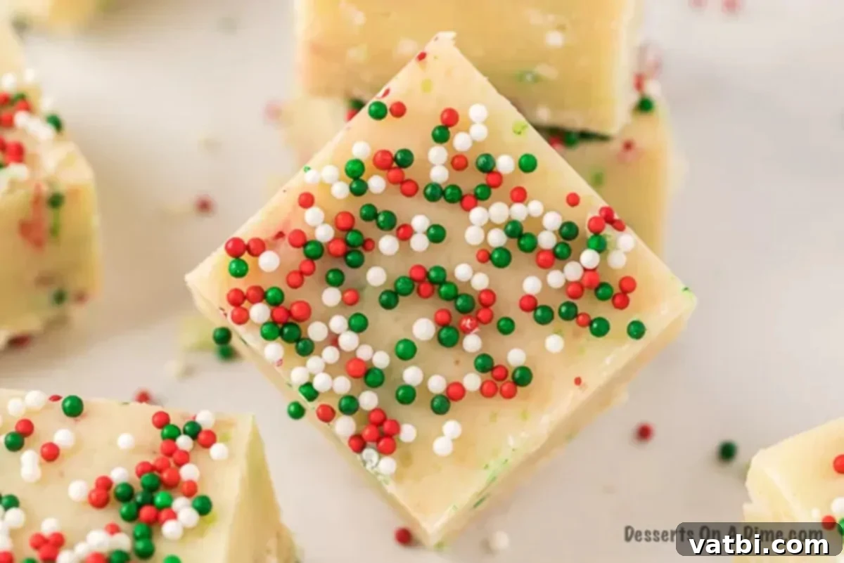 Foolproof Fudge Delights: Holiday Candy Tray Edition 2 Squares of Christmas Fudge with festive sprinkles, arranged on a plate.