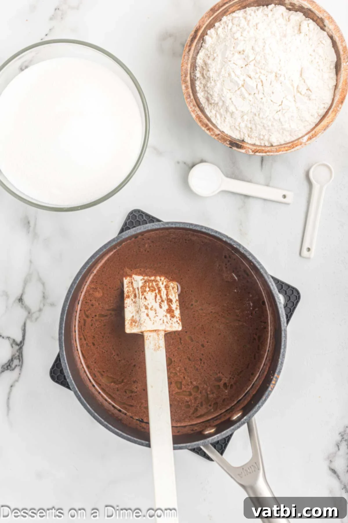 Cocoa powder and butter mixture in saucepan.