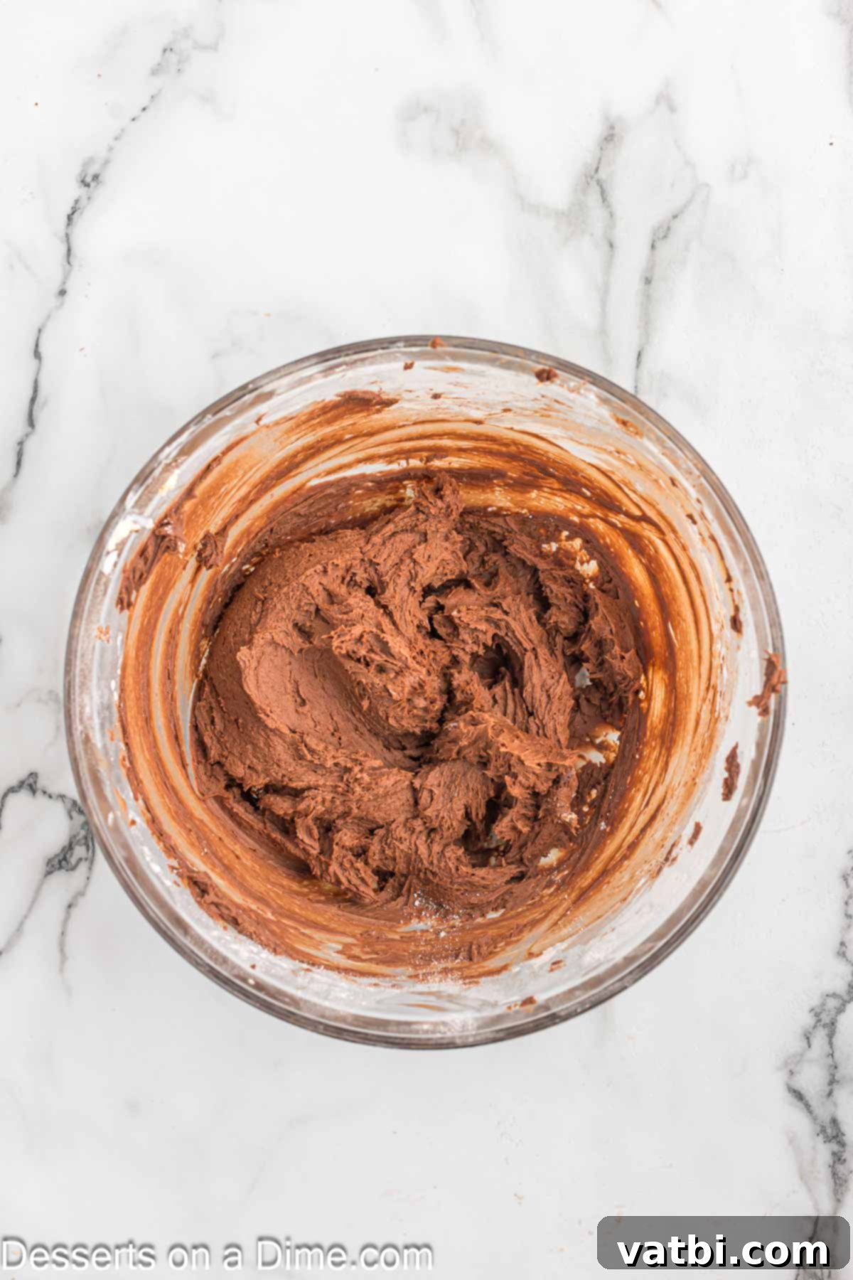 Cocoa powder and heavy cream mixed into butter mixture.