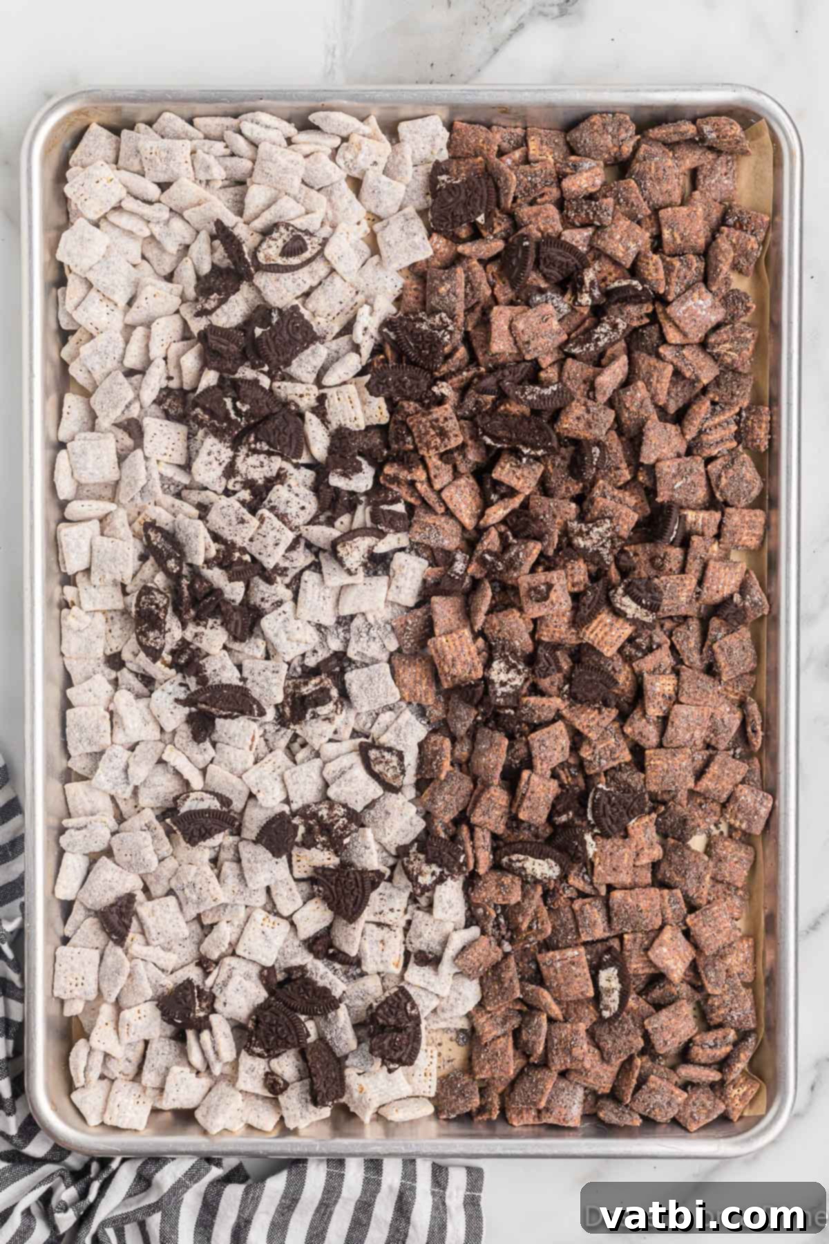 Oreo Muddy Buddies 11 Cereal mixture spread on baking sheet