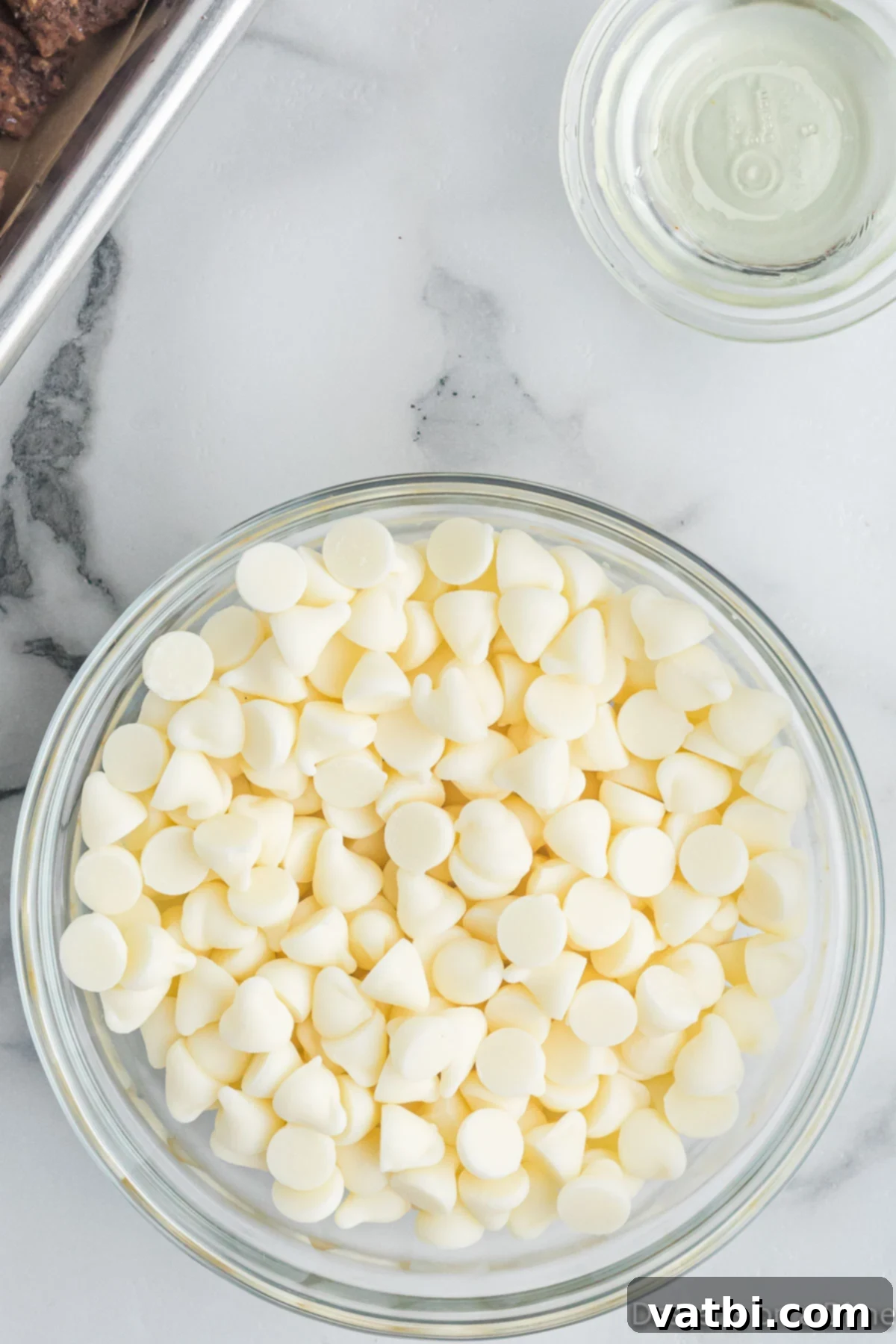 Oreo Muddy Buddies 6 White chocolate chips in a bowl